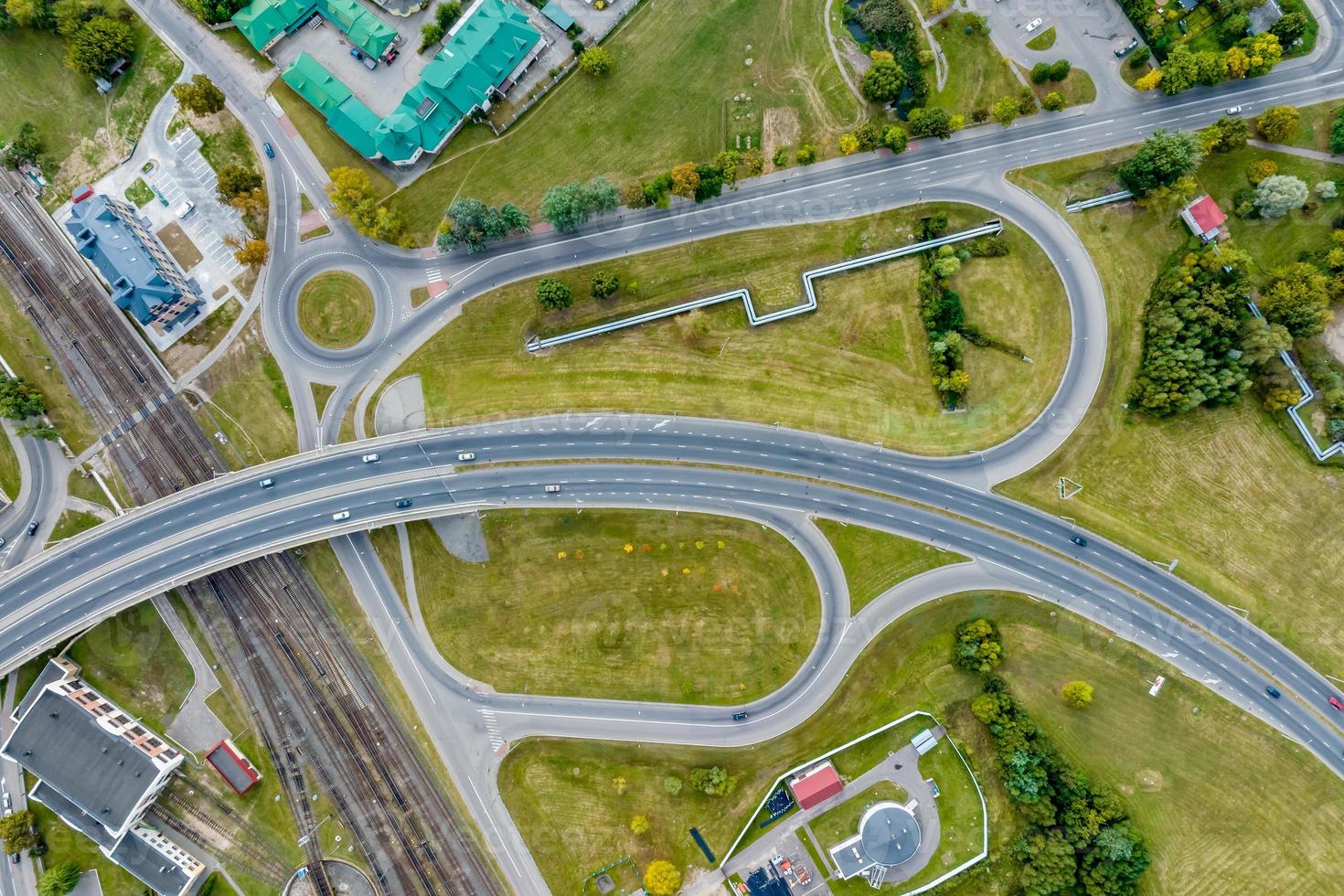aerial view of huge road junction of freeway with heavy traffic at city photo