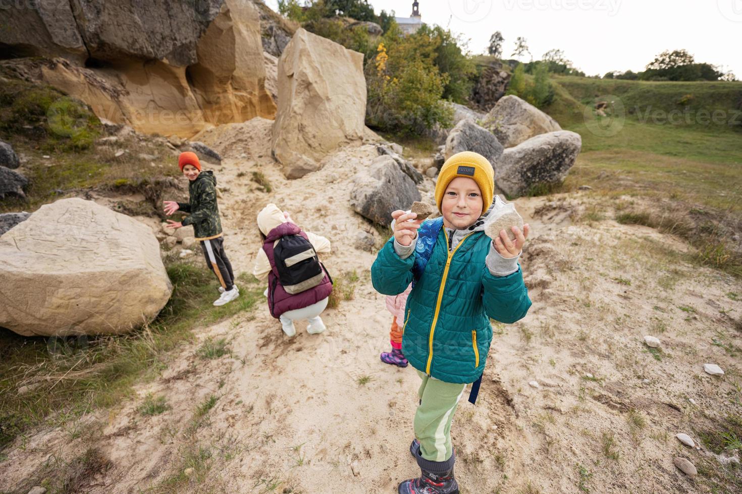 Boy explore limestone stones at mountain in Pidkamin, Ukraine. photo