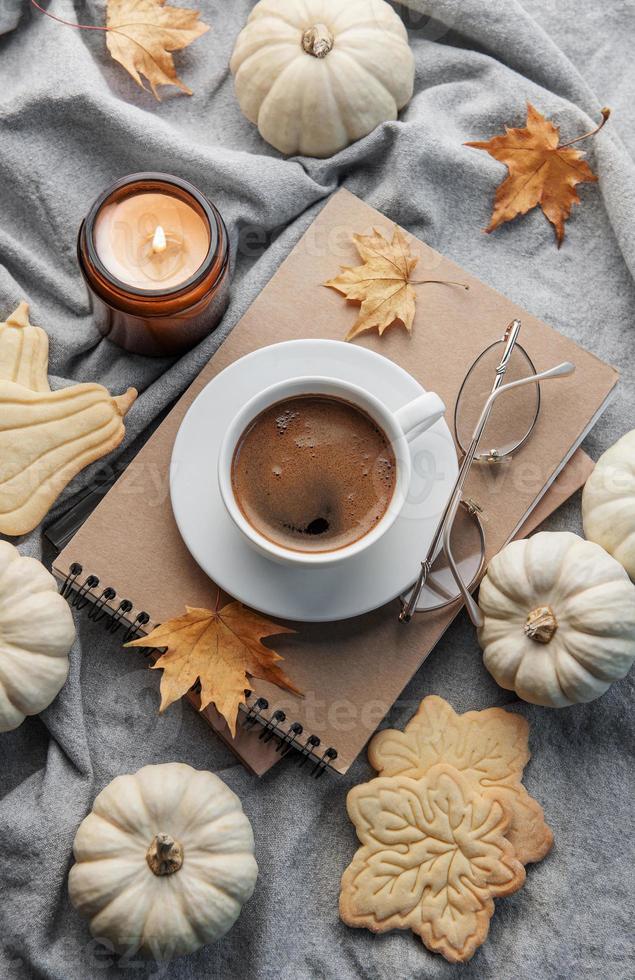 White pumpkins, coffee and autumn leaves photo