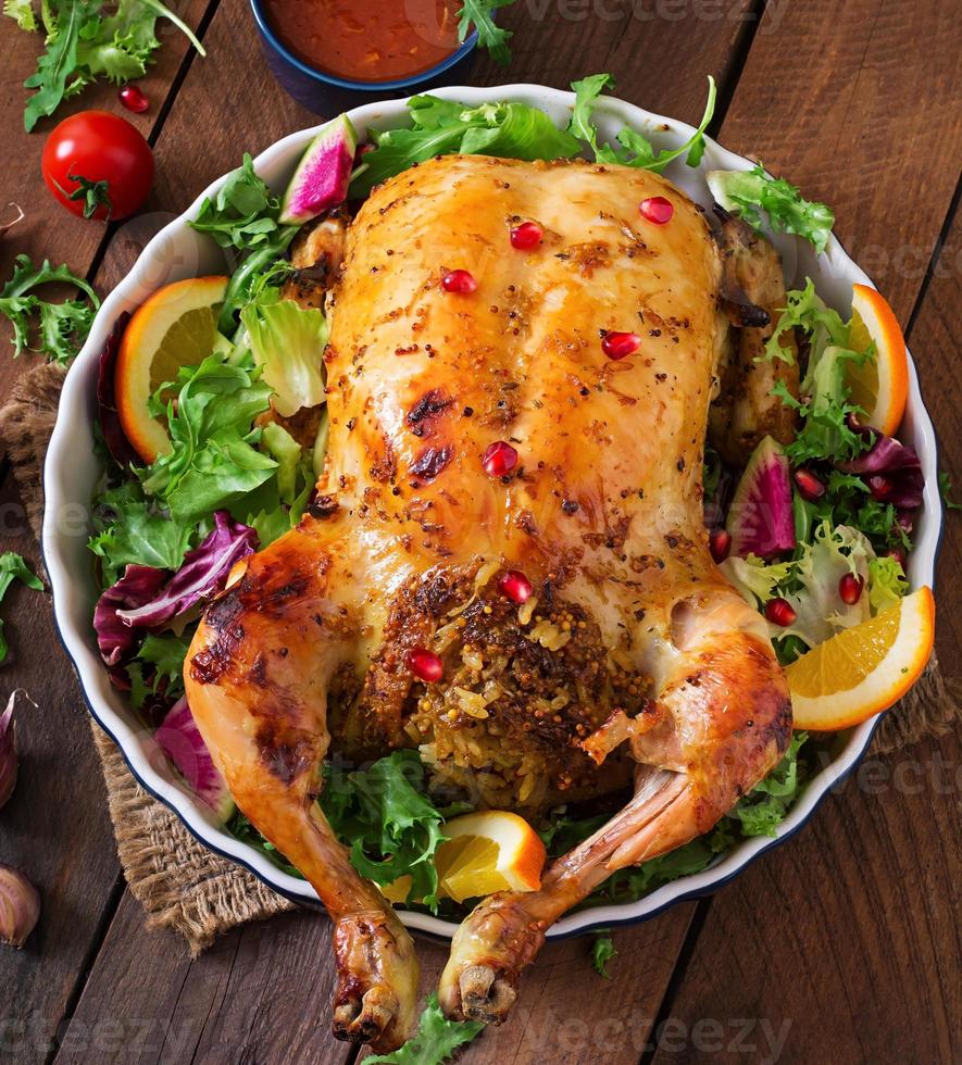 Baked chicken stuffed with rice for Christmas dinner on a festive table photo