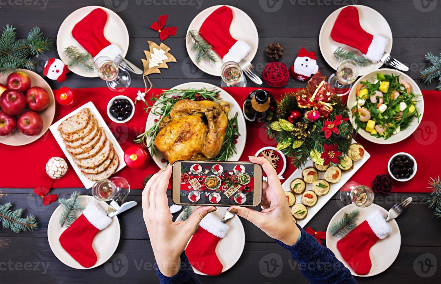 Baked turkey. Christmas dinner. The Christmas table is served with a turkey, decorated with bright tinsel and candles. Fried chicken, table.  Family dinner. Top view photo