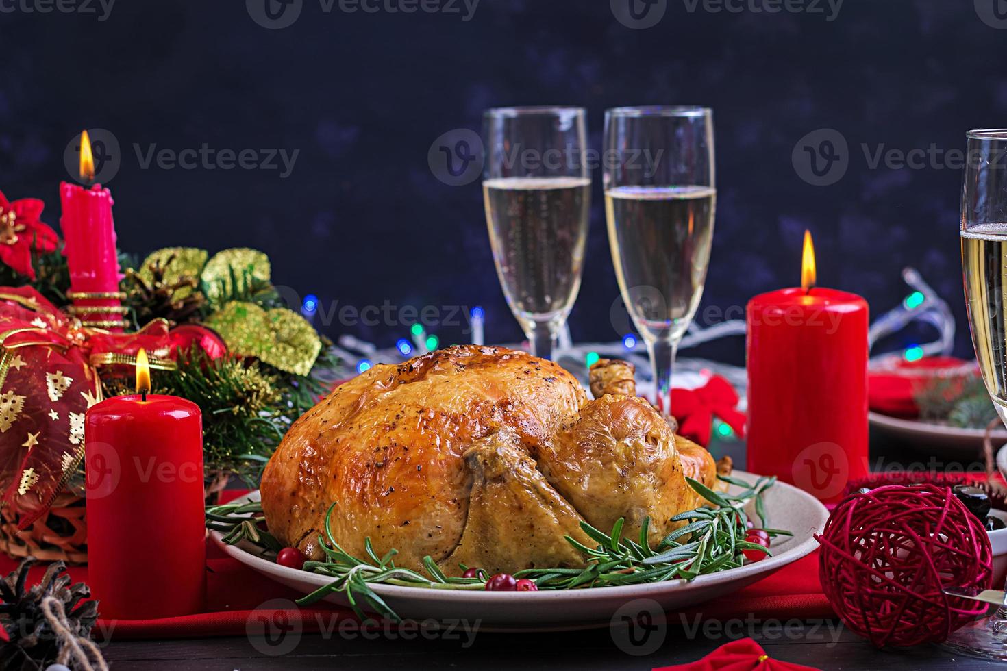 Baked turkey. Christmas dinner. The Christmas table is served with a turkey, decorated with bright tinsel and candles. Fried chicken, table.  Family dinner. photo