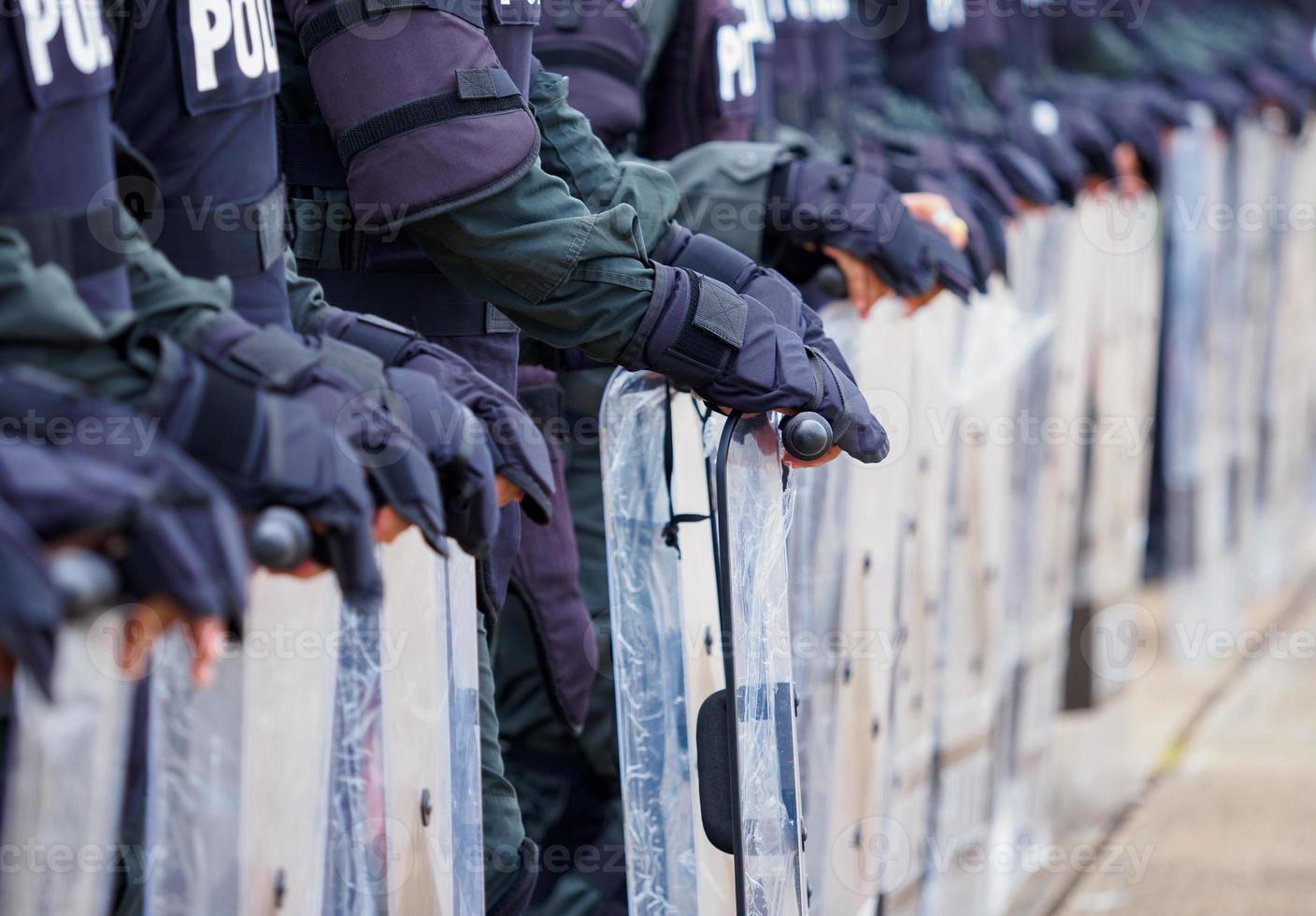 Crowd control police practice using shields and batons. photo