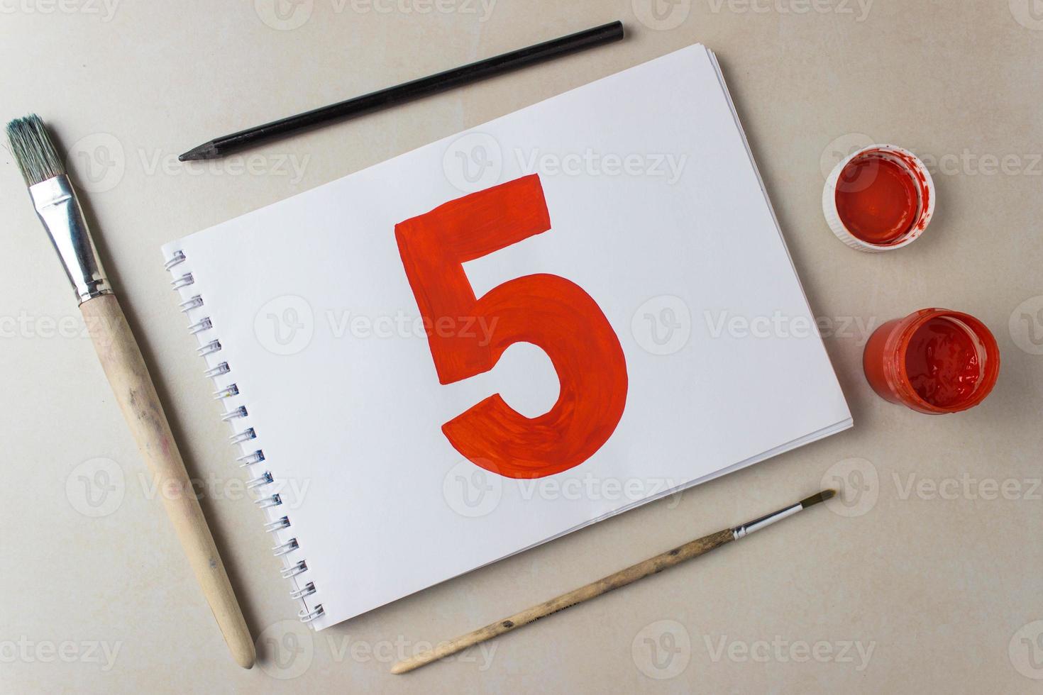 Red number five drawing on a white album sheet. To indicate the place, price, etc. photo