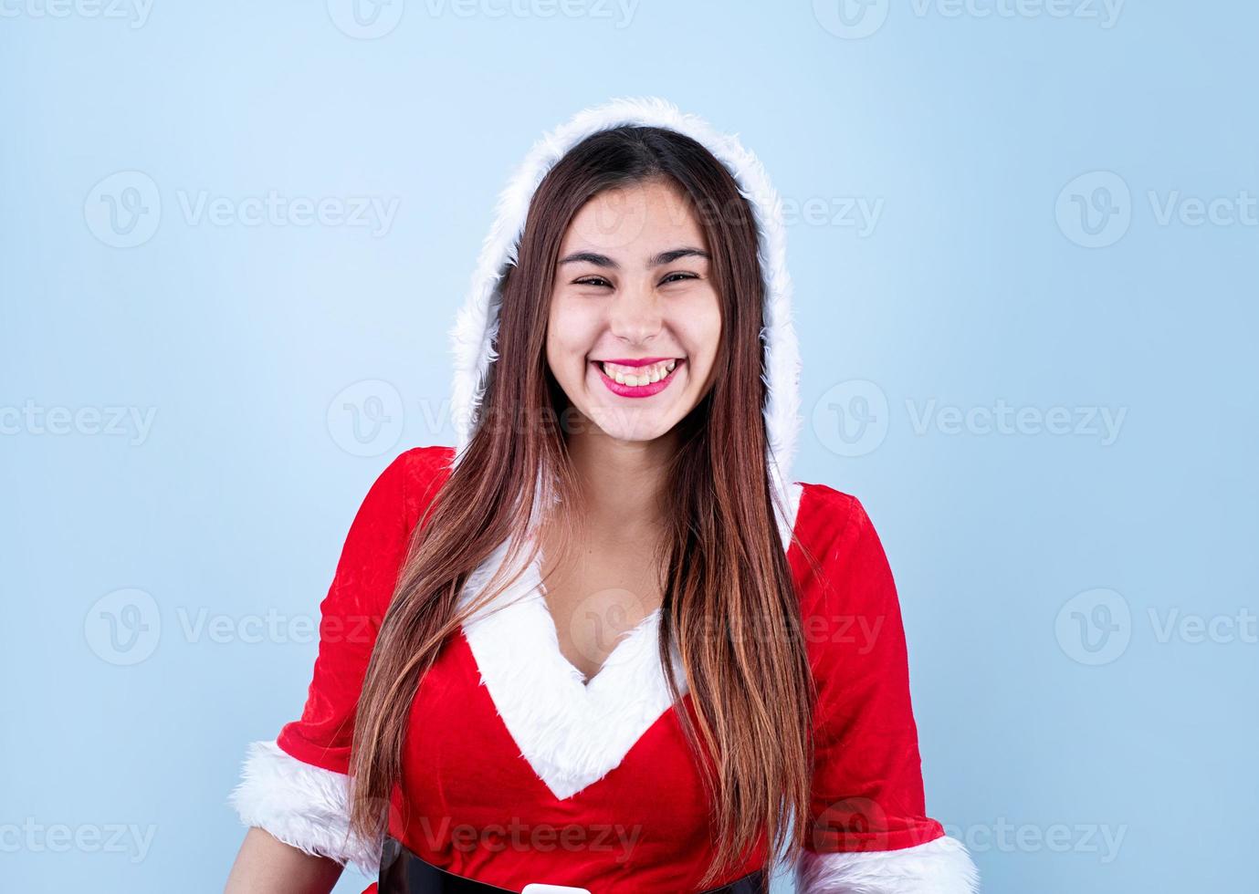 closeup of happy caucasian woman wearing santa clothes smiling photo