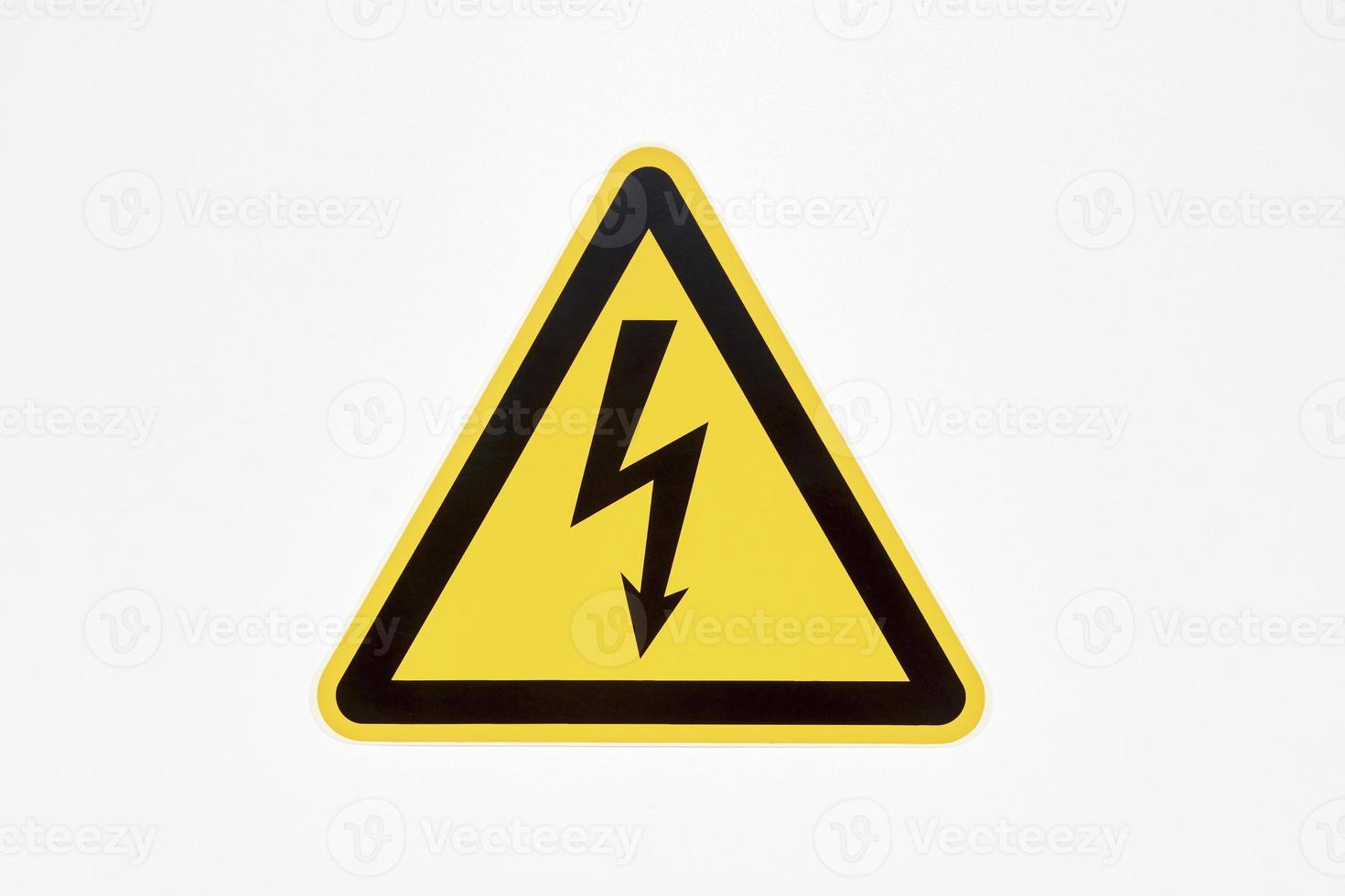 Danger sign of high voltage electricity. Yellow triangular mesh with a zipper in the center photo