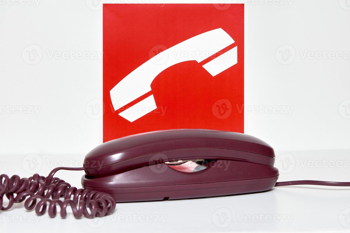 Sign indicating the location of the phone to use in case of fire photo