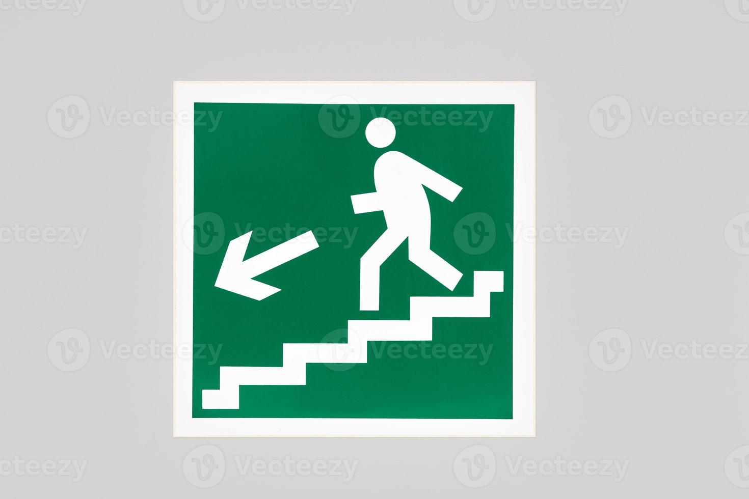 The exit sign during a fire with a graphic man and a staircase photo