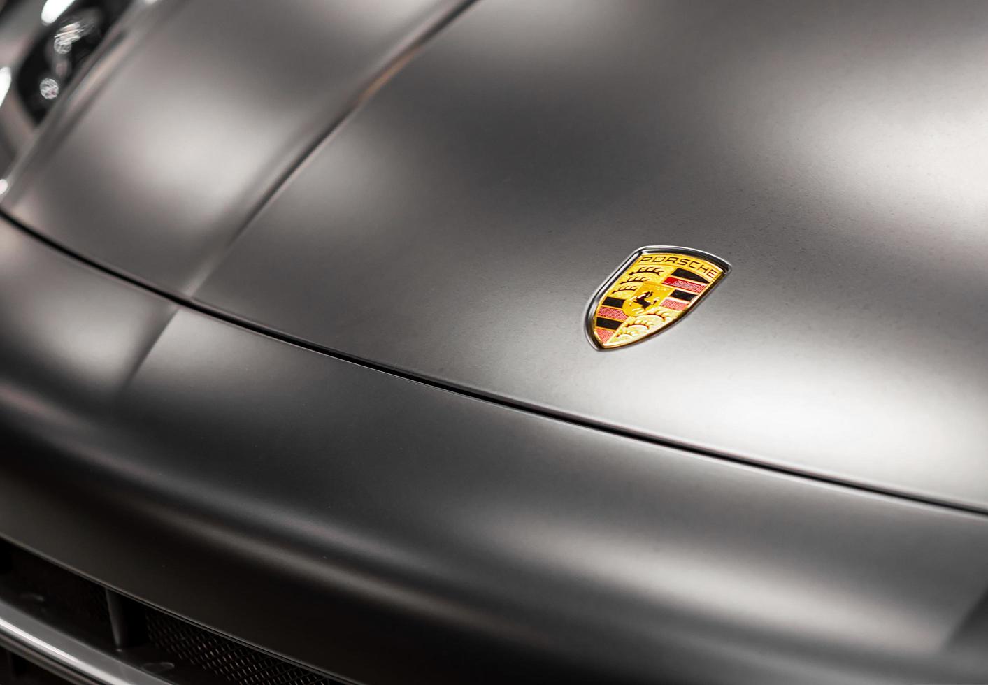 Installation of a protective paint and varnish matte film on Porsche Cayenne car. PPF polyurethane film protects car paint from stones, blurred focus. Chelyabinsk, Russia, April 03, 2021 photo