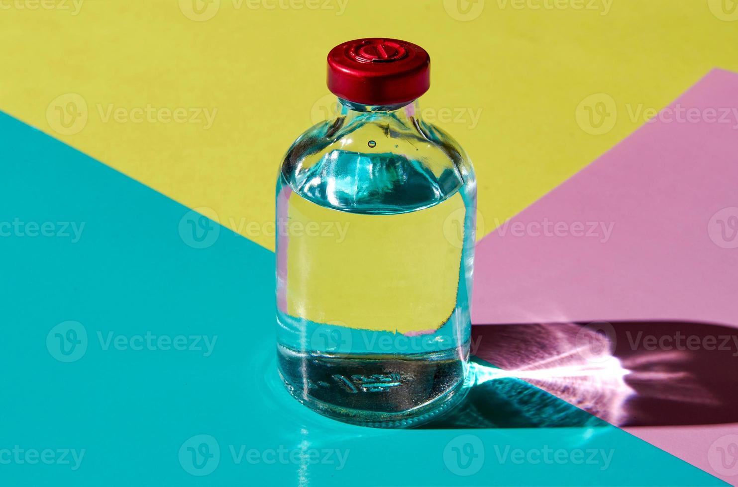 A bubble with a transparent liquid on a colored background. The concept of a medicinal product. photo