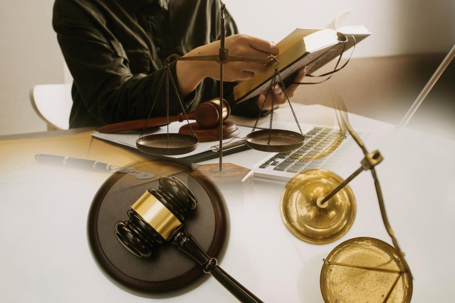 Business and lawyers discussing contract papers with brass scale on desk in office. Law, legal services, advice, justice and law concept picture with film grain effect photo