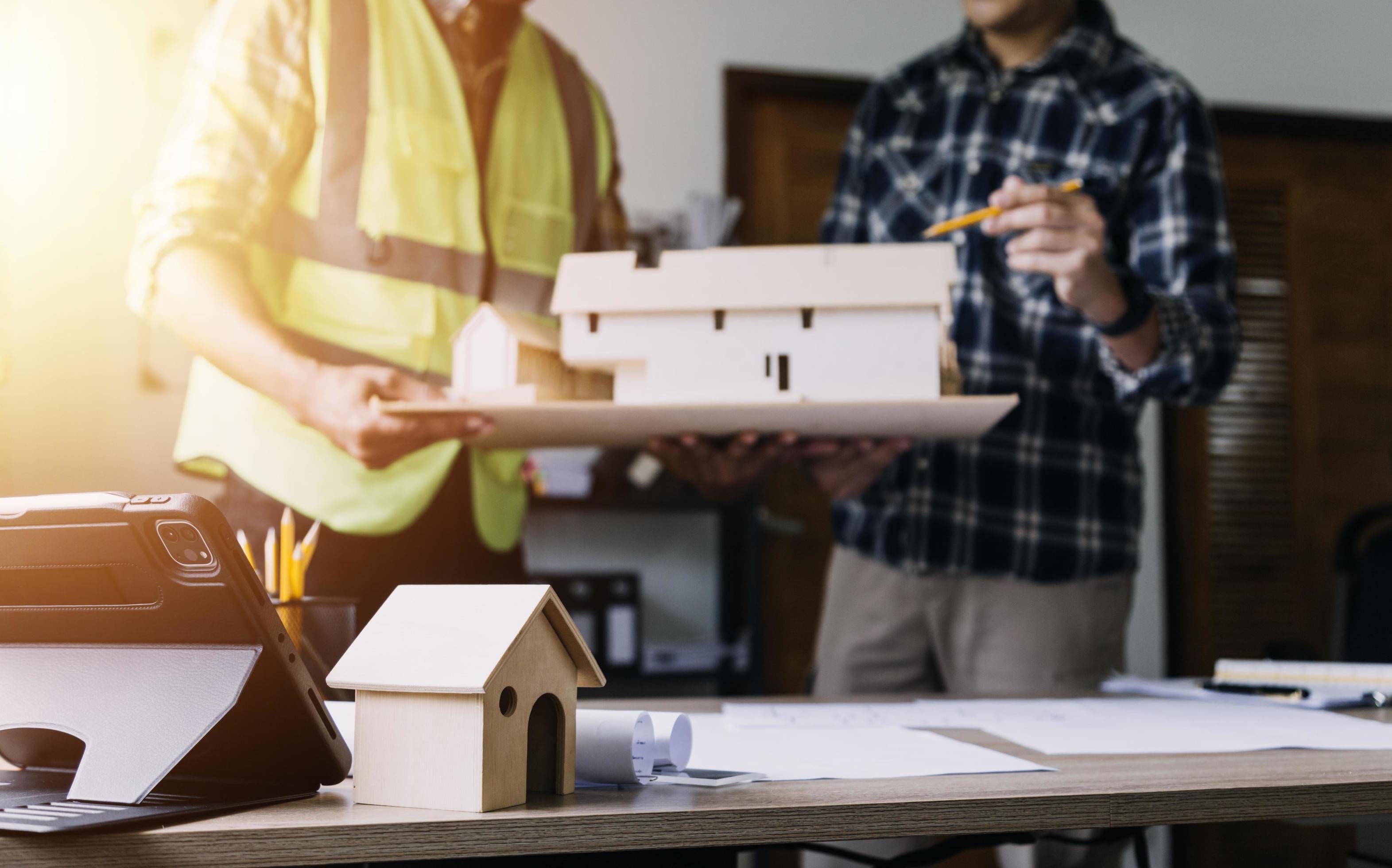 Construction engineer working at blueprint to build large commercial