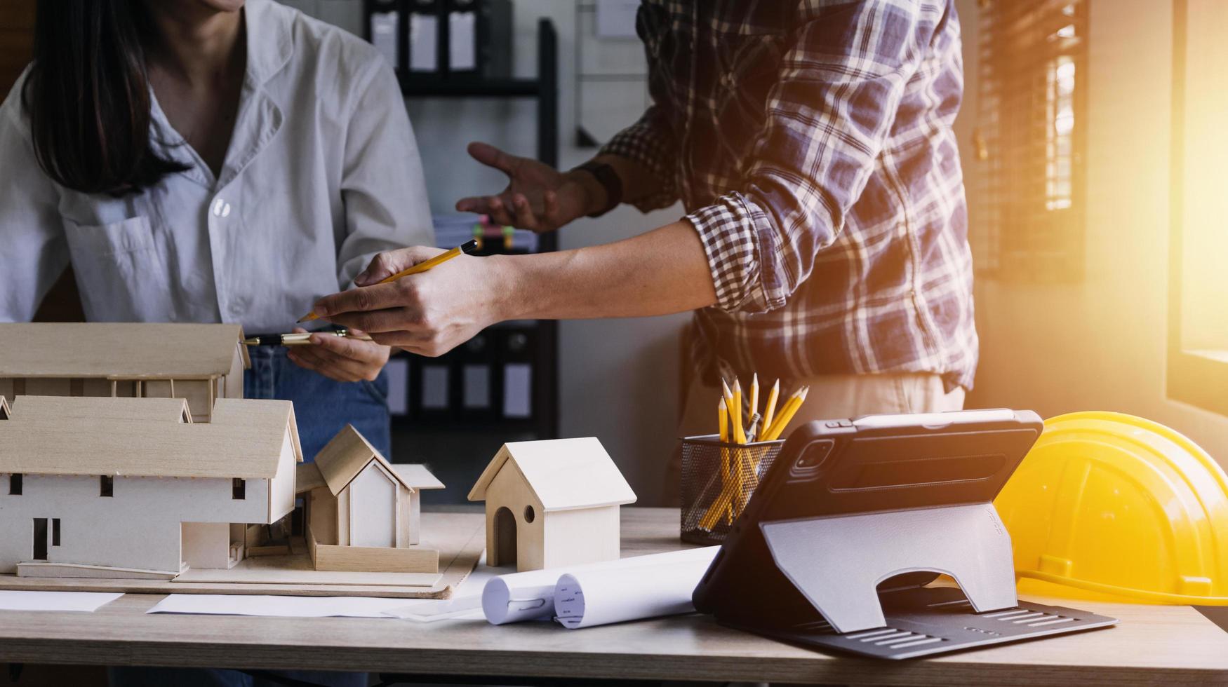 Construction engineer working at blueprint to build large commercial buildings in office. Engineering tools and construction concept. photo