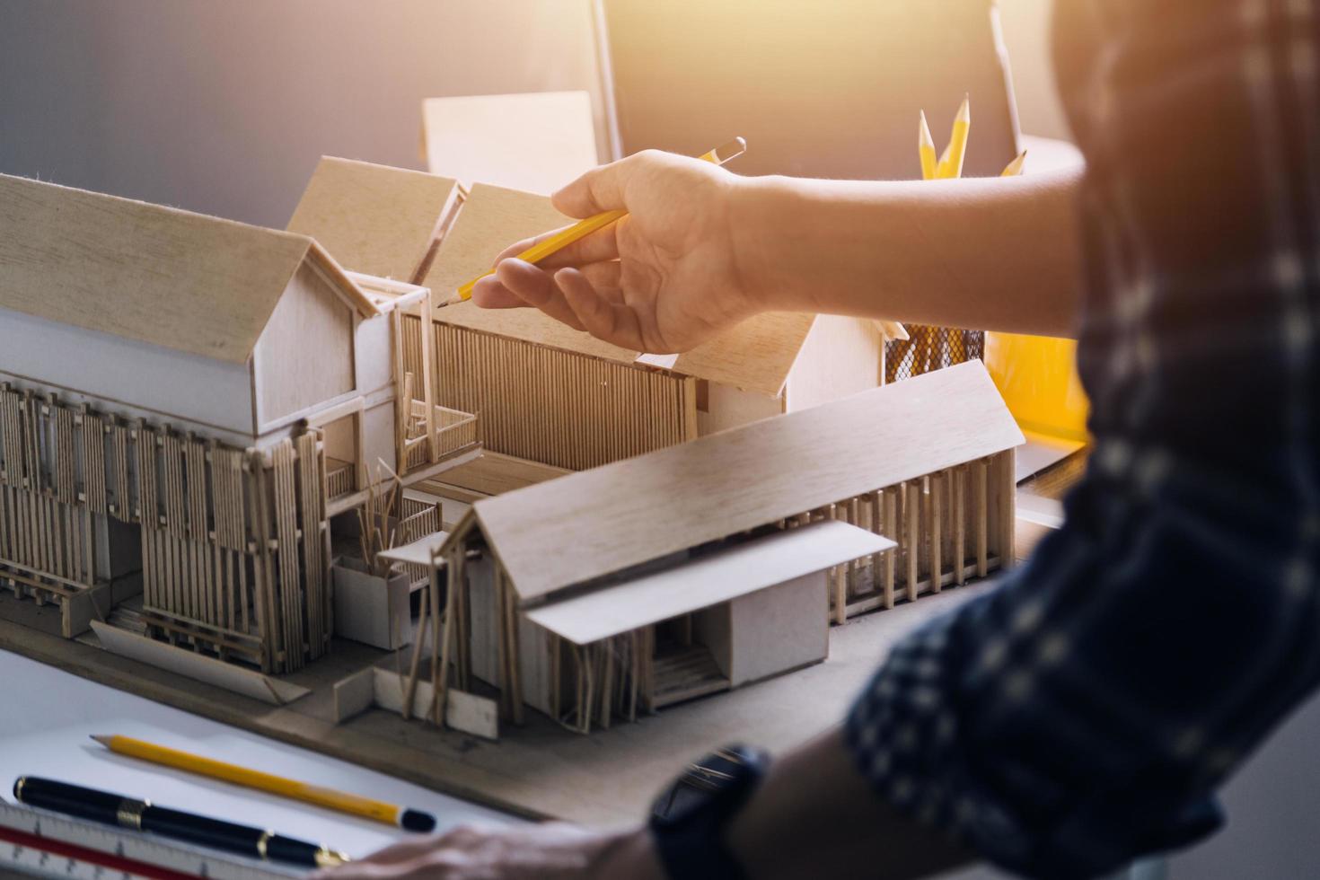 Construction engineer working at blueprint to build large commercial buildings in office. Engineering tools and construction concept. photo