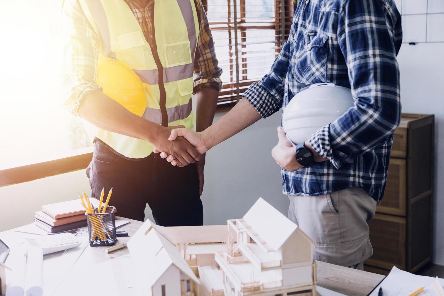 Construction engineer working at blueprint to build large commercial buildings in office. Engineering tools and construction concept. photo
