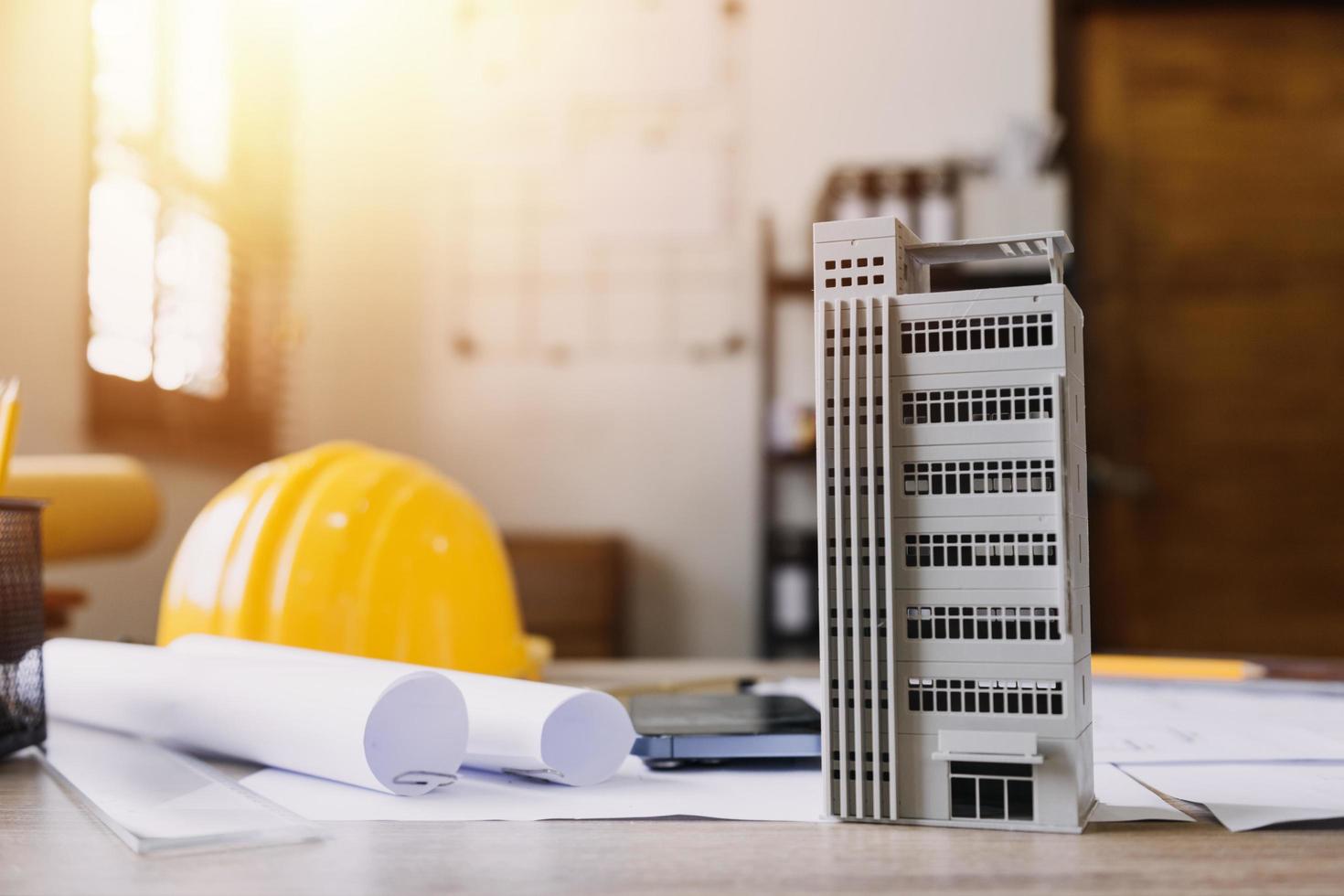 Construction engineer working at blueprint to build large commercial buildings in office. Engineering tools and construction concept. photo