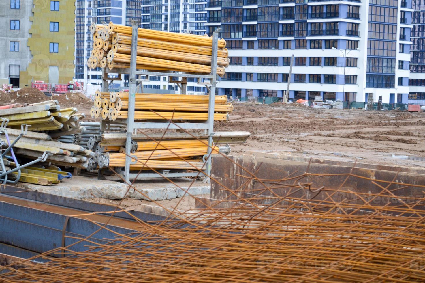 A lot of building materials with metal spare parts, sticks, beams, pipes at an open-air construction site warehouse photo