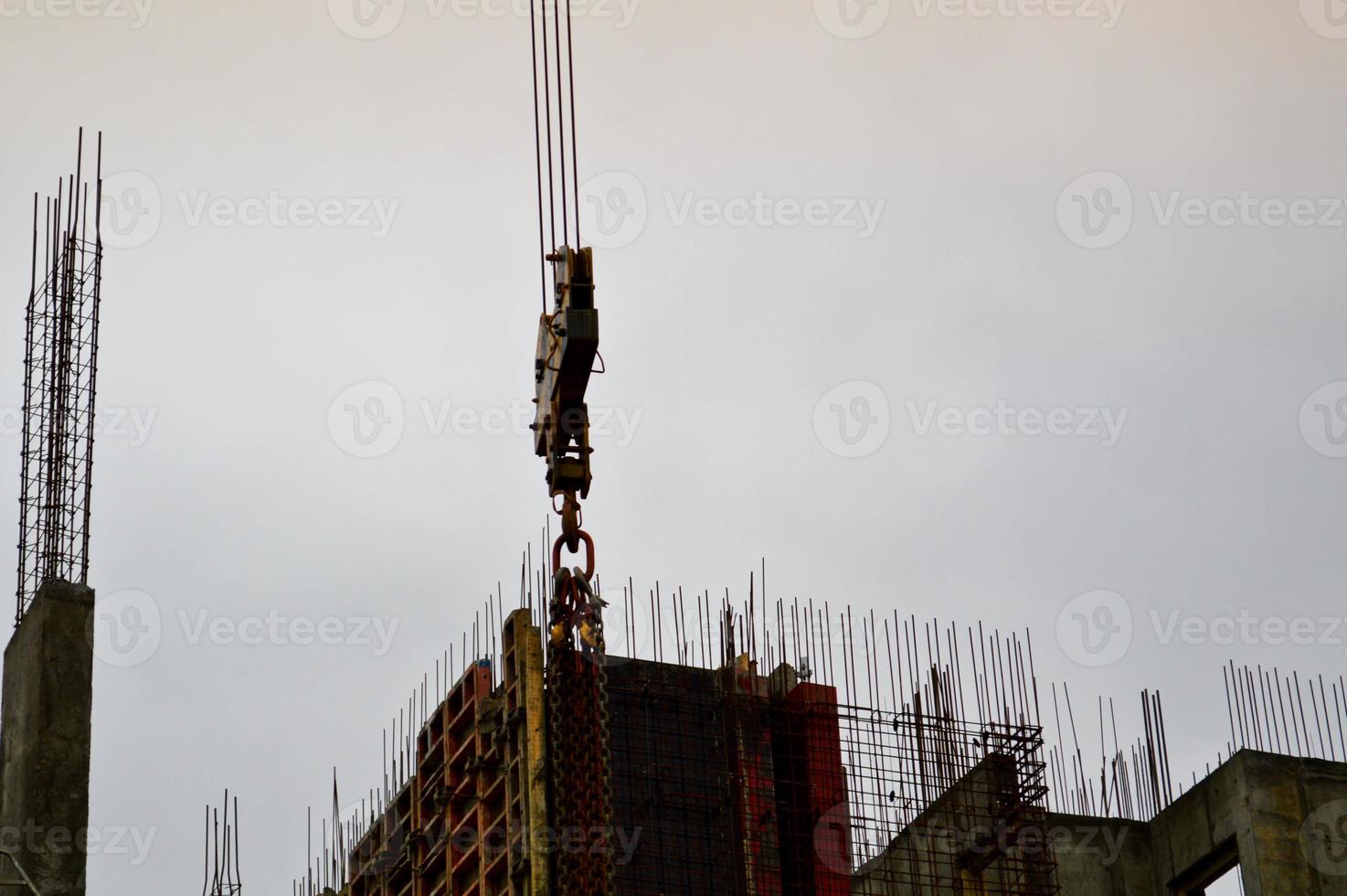 The process of construction and repair of a new modern cement concrete stone pannel monolithic frame-block building of a house with iron reinforcement at an industrial construction site photo