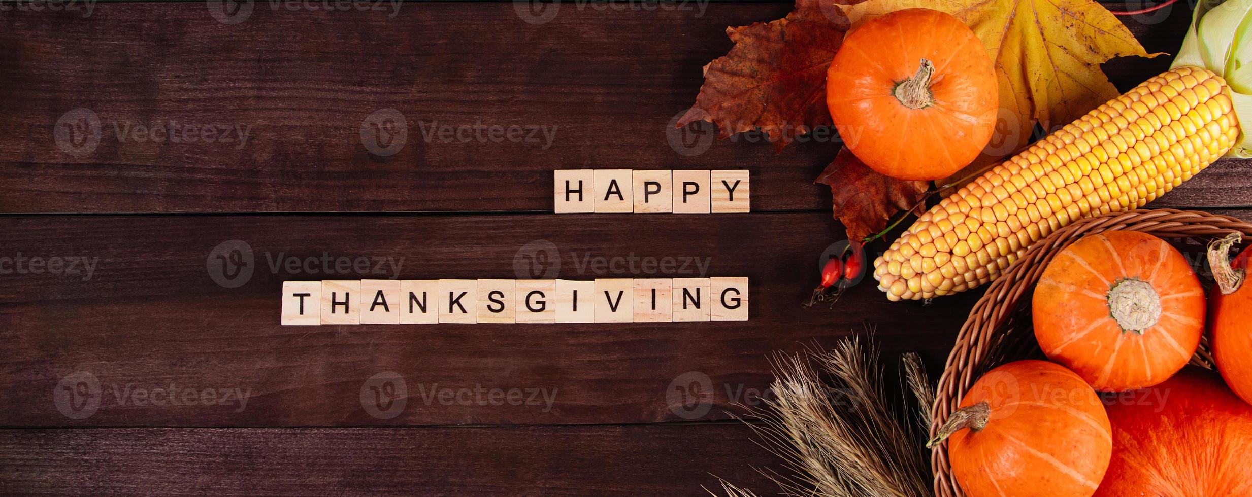 Autumn harvest and Thanksgiving. Ripe pumpkins, corn and wheat on wooden background. Banner format. photo