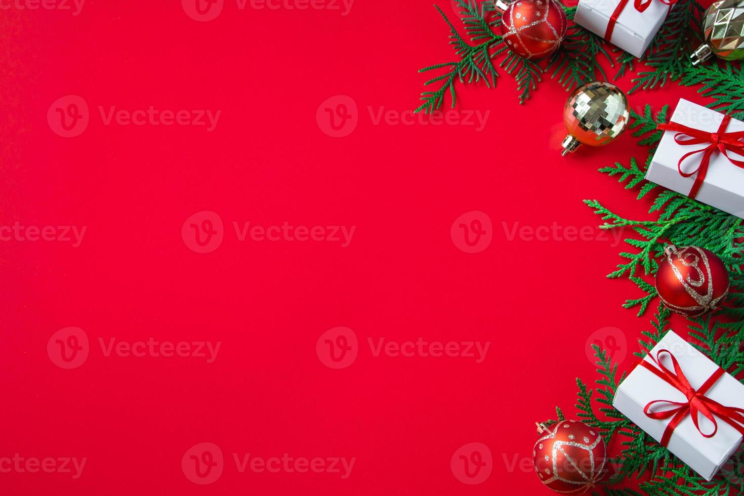 Gift boxes and festive decor. Christmas composition on red background. photo