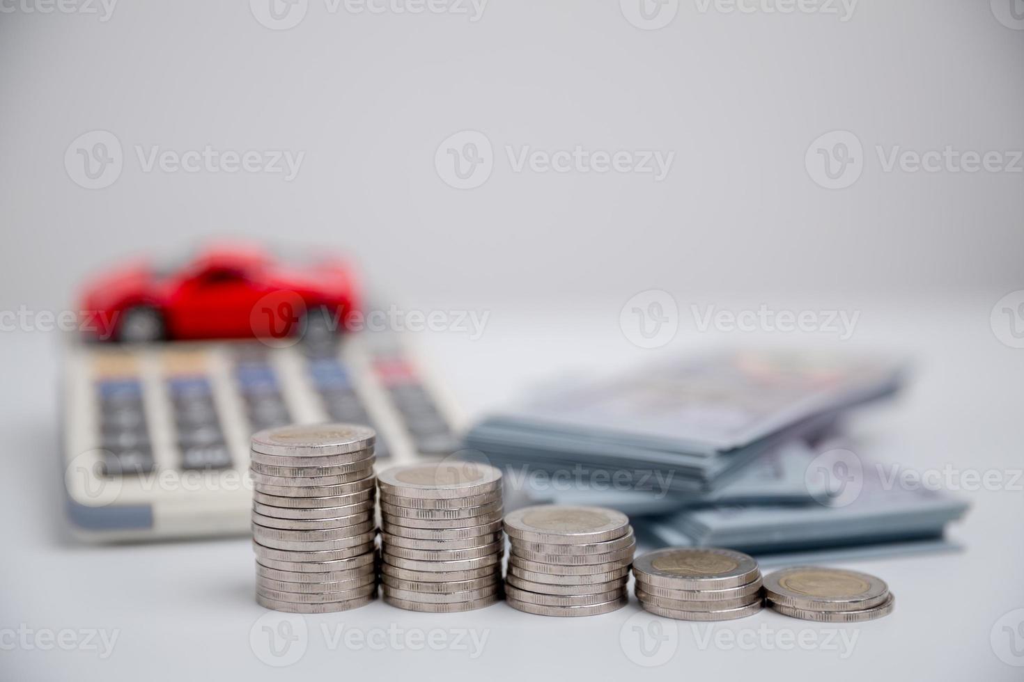 Concept of car insurance business, saving buy - sale with tax and loan for new car. Car toy vehicle with stack coin money on background. Planning to manage transportation finance costs. loan for car photo