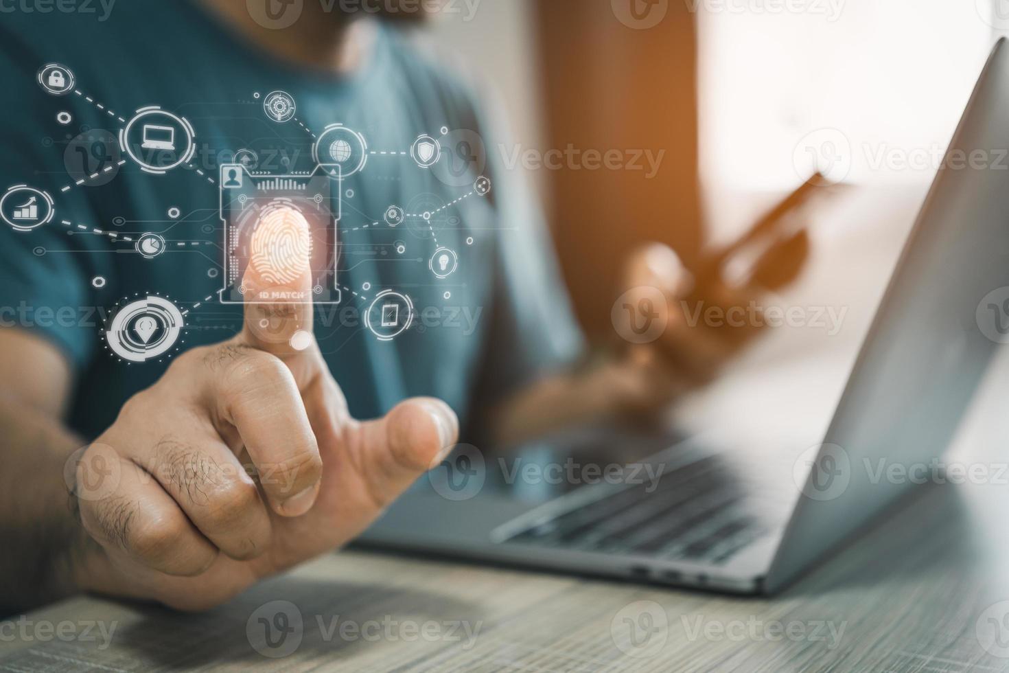 Man using fingerprint scan provides security access with biometrics identification on screen and using laptop and mobile. Business Technology Safety Internet Network Concept. The security scanning. photo