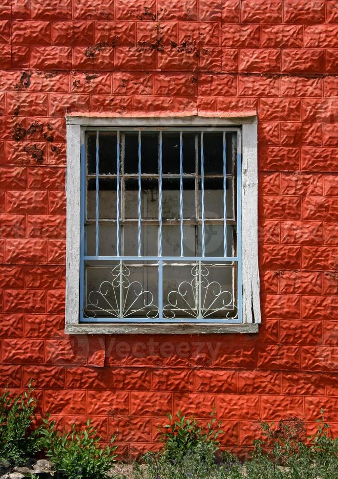 Window on red facade building photo