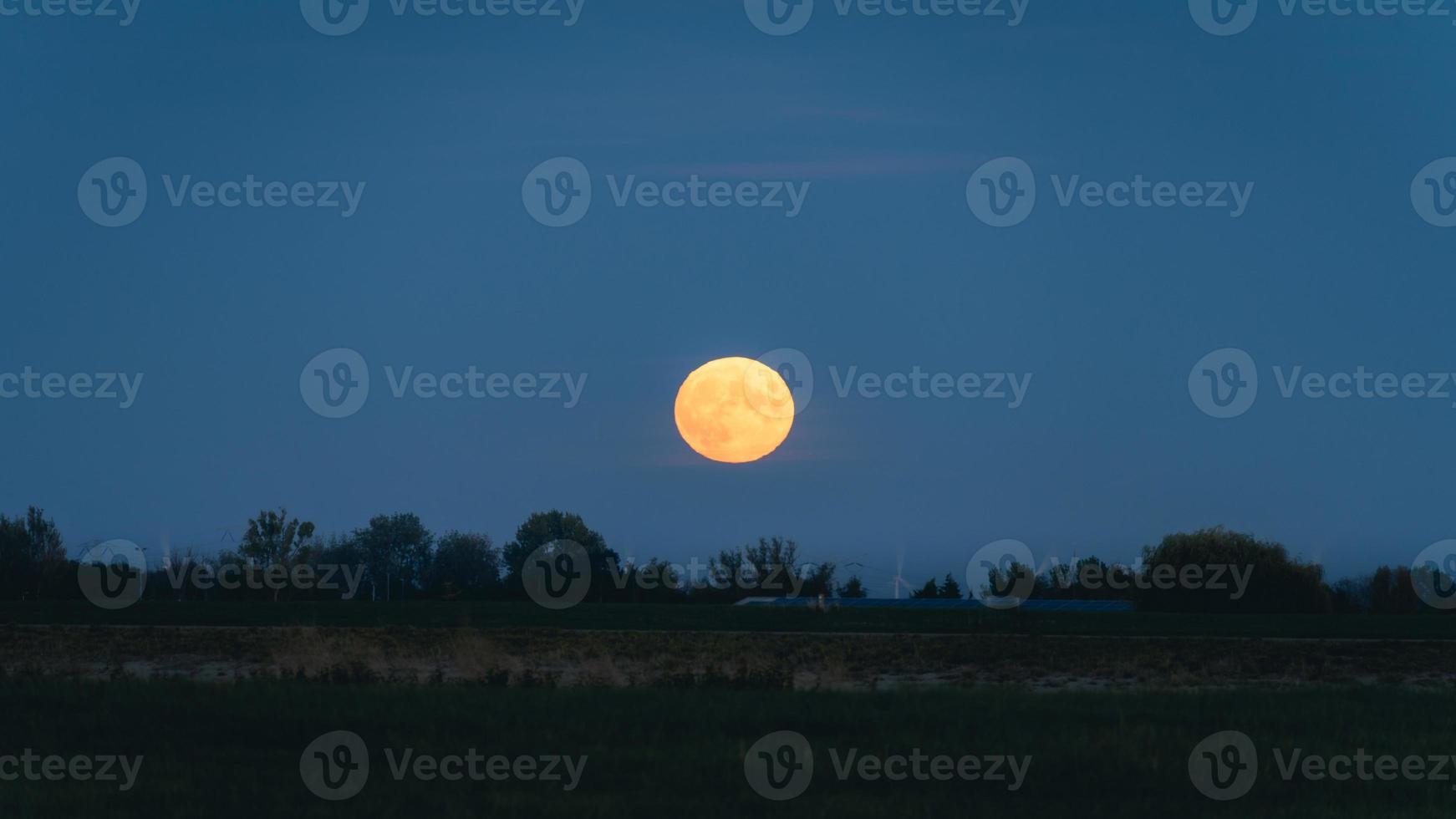 full moon rise up at Hansweert Zeeland, The Netherlands. photo