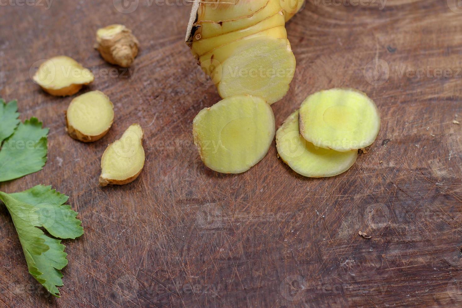 Galangal cut into thin strips with celery leaves. photo