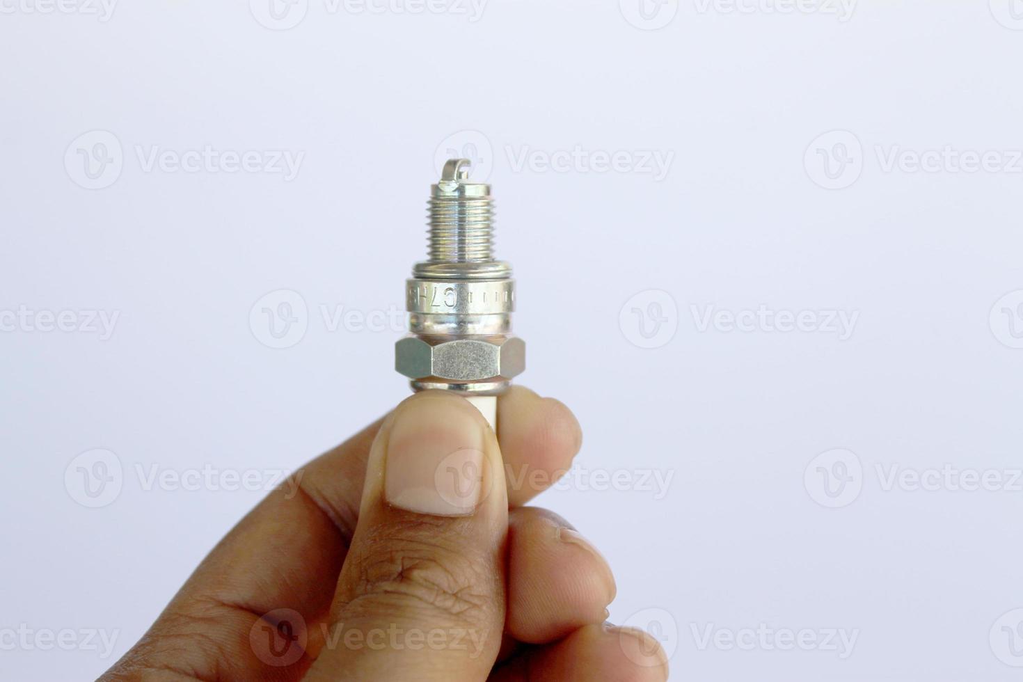 New spark plug in hand before use. photo