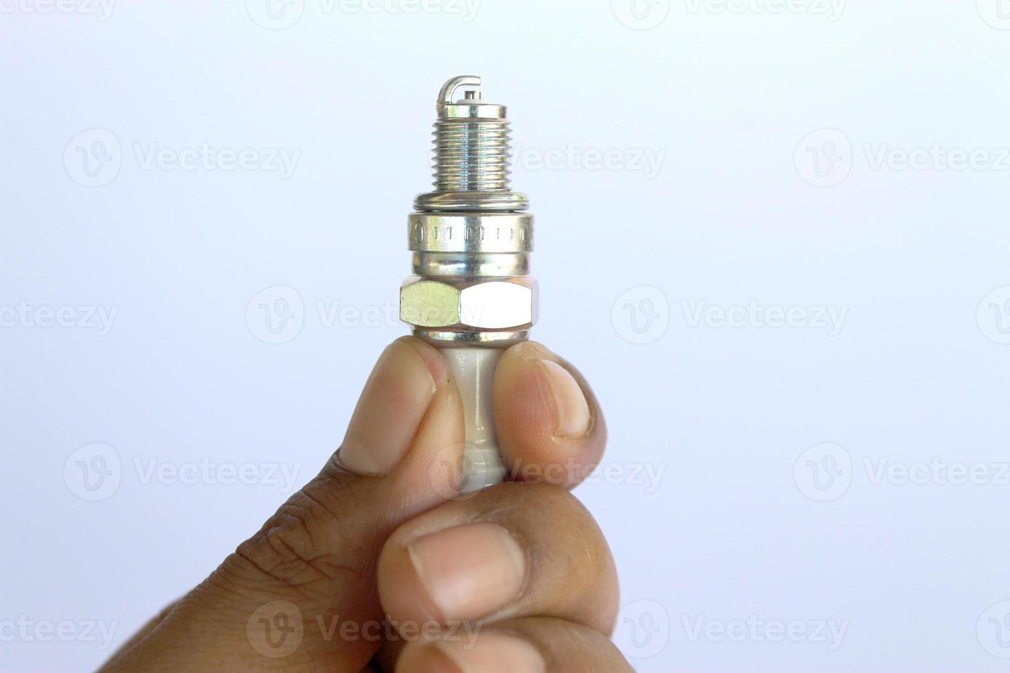 New spark plug in hand before use. photo