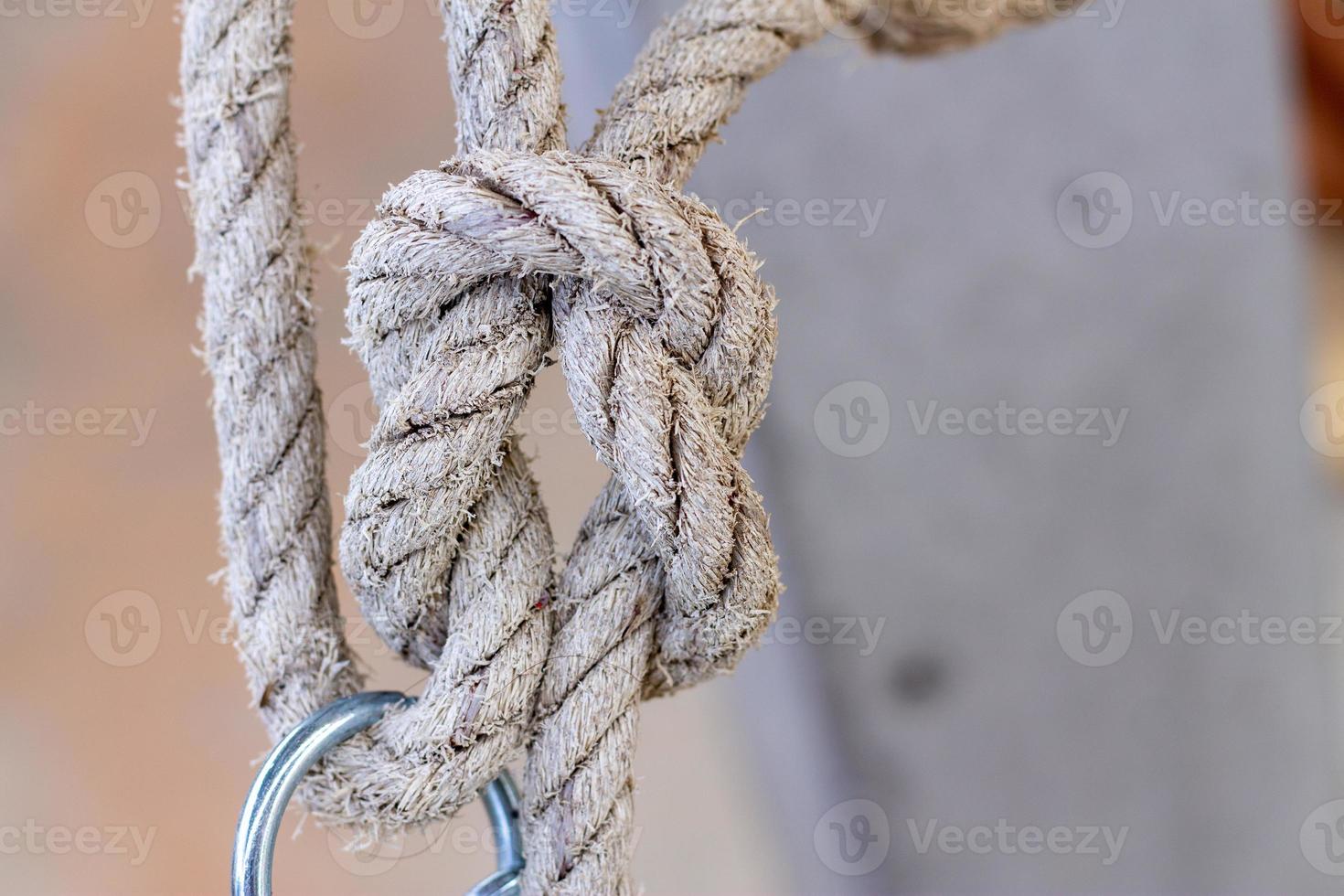 nautical knots made of rough natural rope isolated on blurred background photo