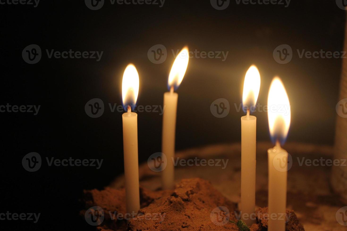 candles burning brightly on black background photo