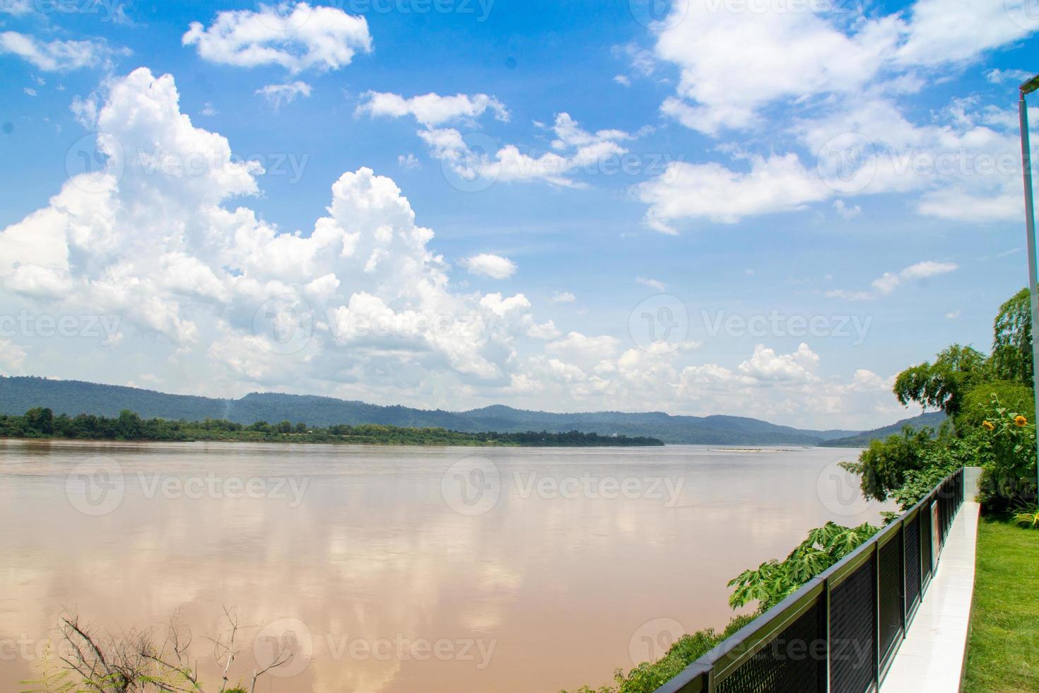 Mekong River View from a garden along the Mekong River Will see mountains and fog White clouds as background photo