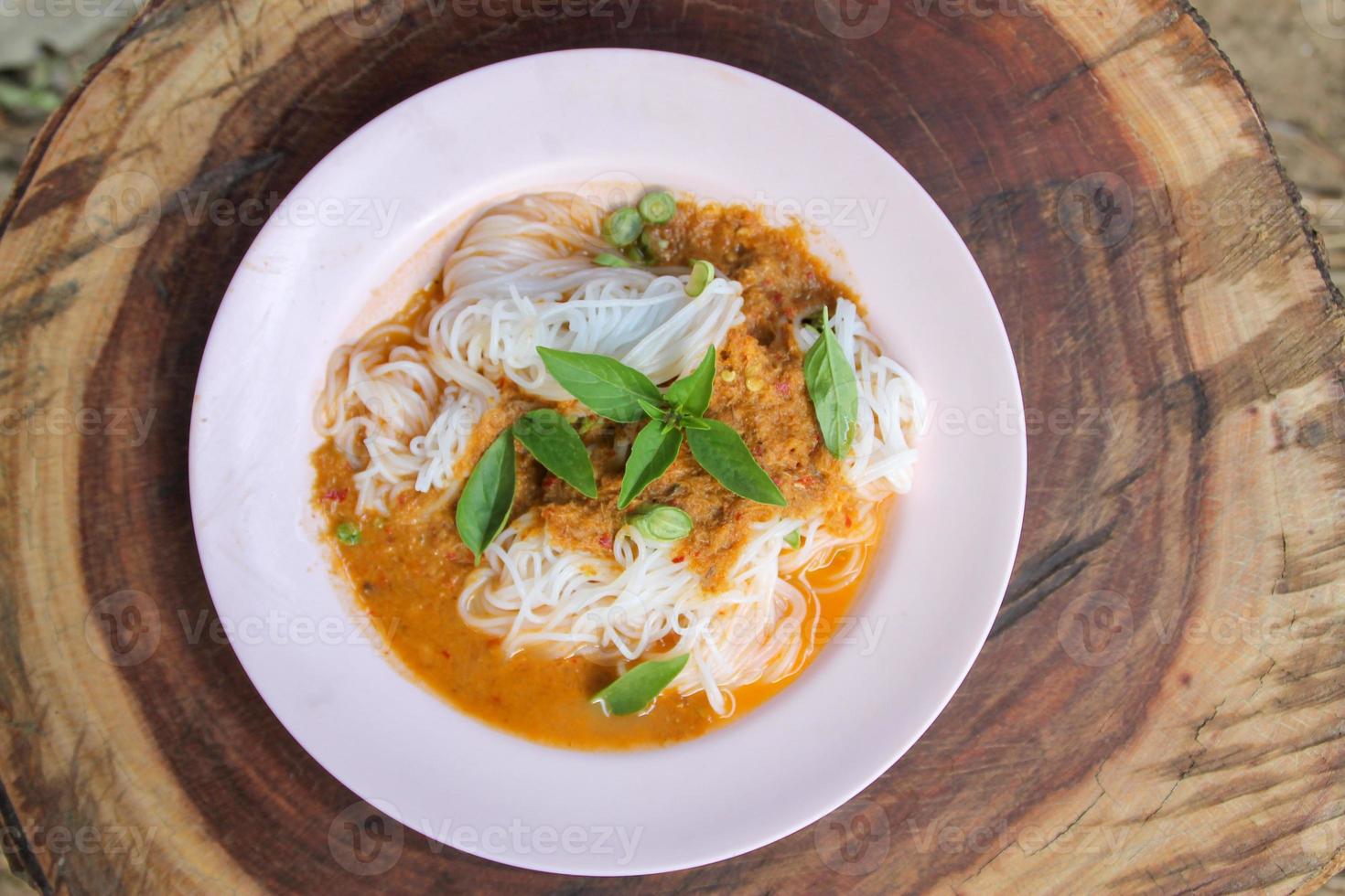 Fresh noodles with spicy Thai curry is a local food in Southern of Thailand. photo