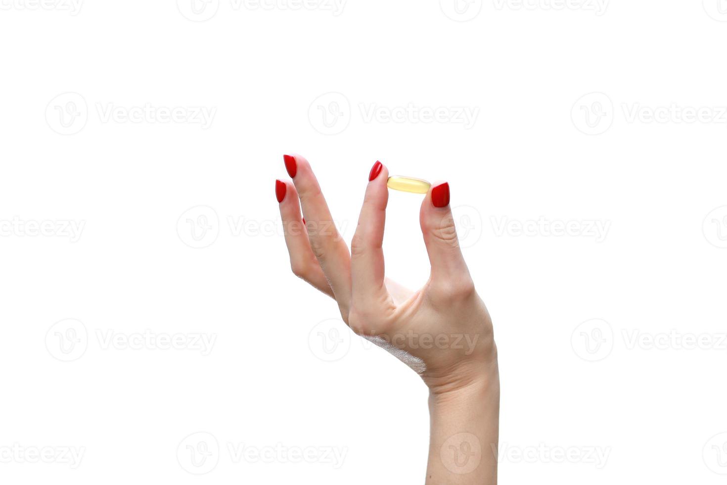 Hand holding capsule of Omega 3 on white background. Close up. High resolution product. Health care concept photo