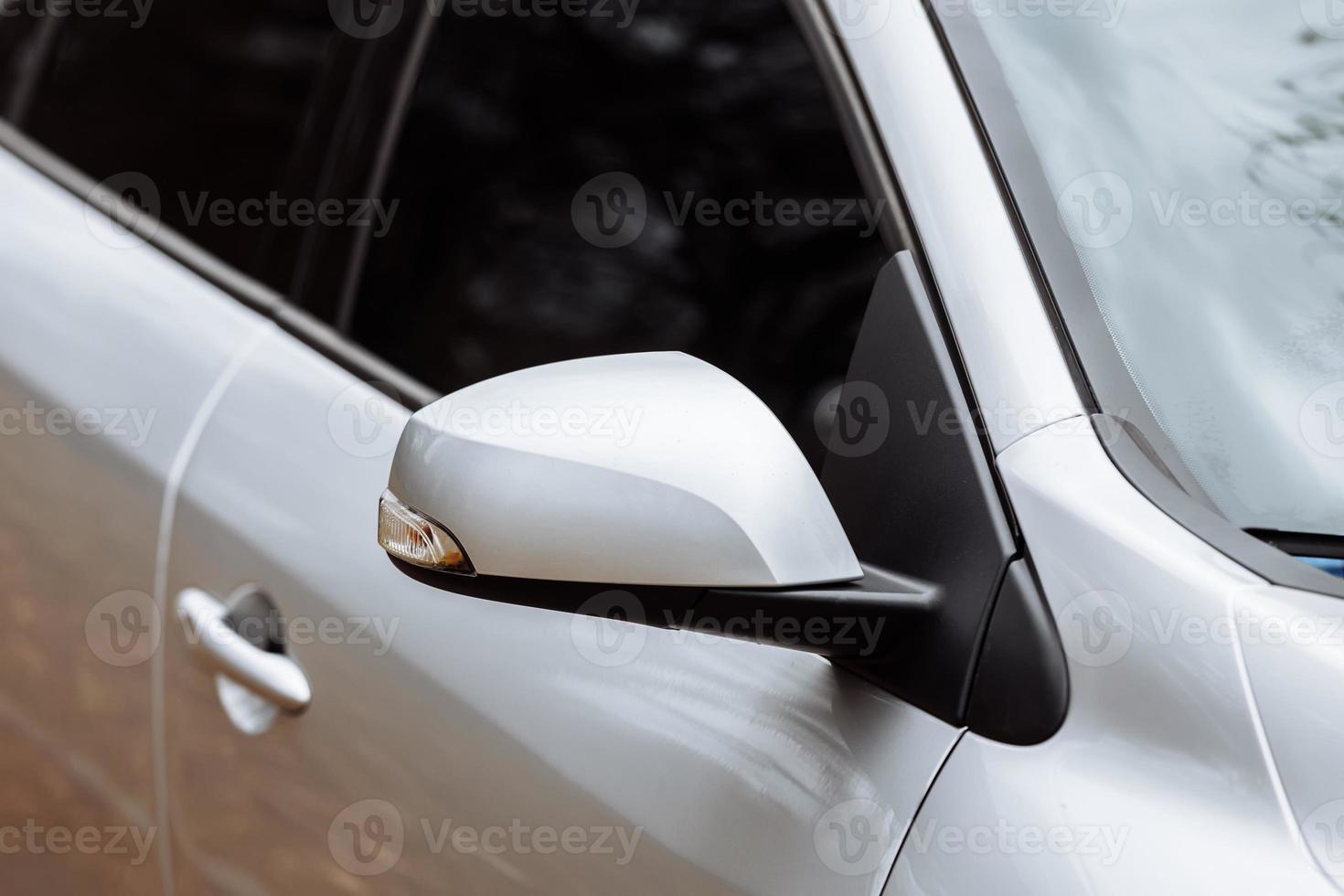 gray side mirror of the car with turn signal repeaters. Exterior new car. side mirror of the car with turn signal repeaters. Exterior new car. photo