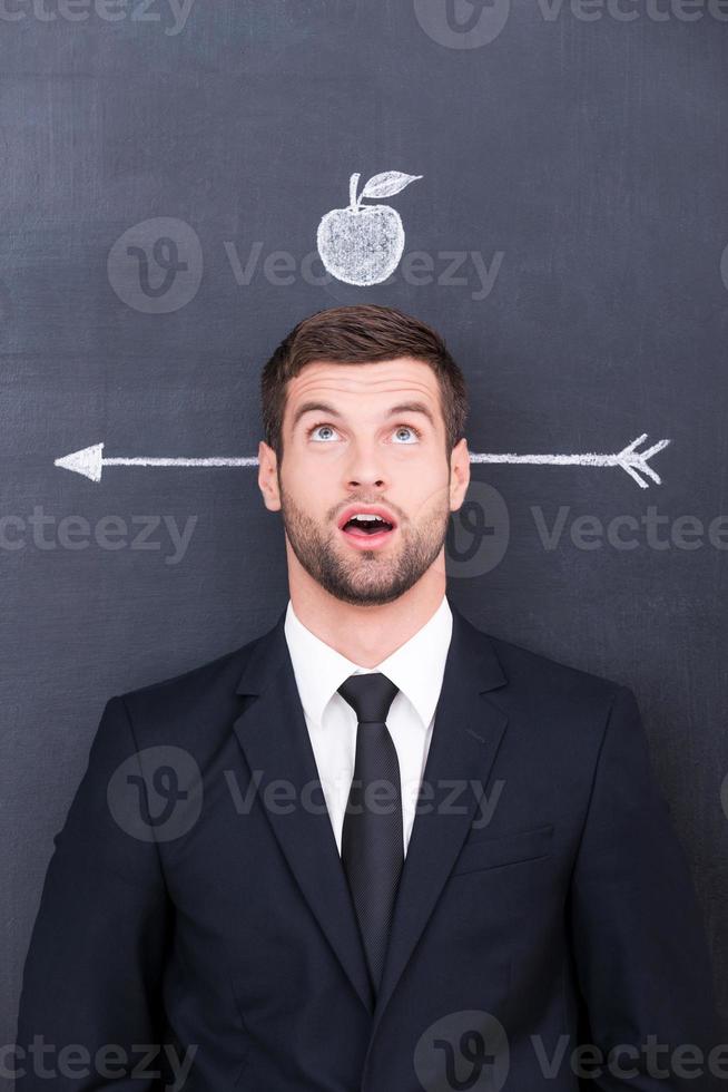 Something wrong Handsome young man in shirt and tie looking up photo