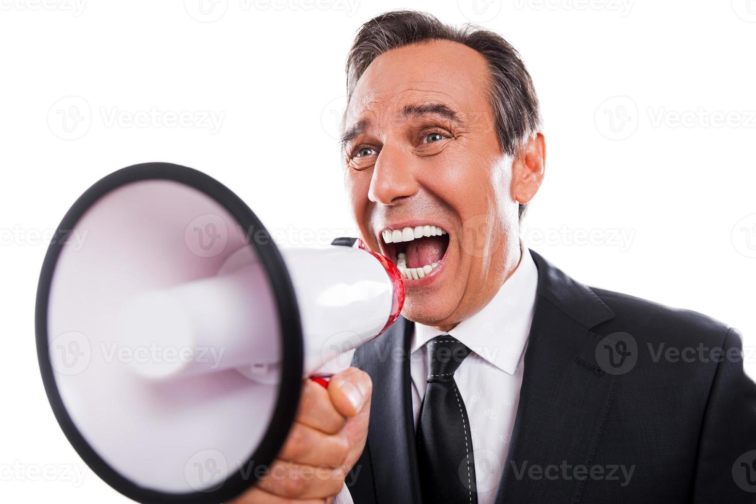 Can you hear me Furious mature man in formalwear shouting at megaphone while standing isolated on white background photo