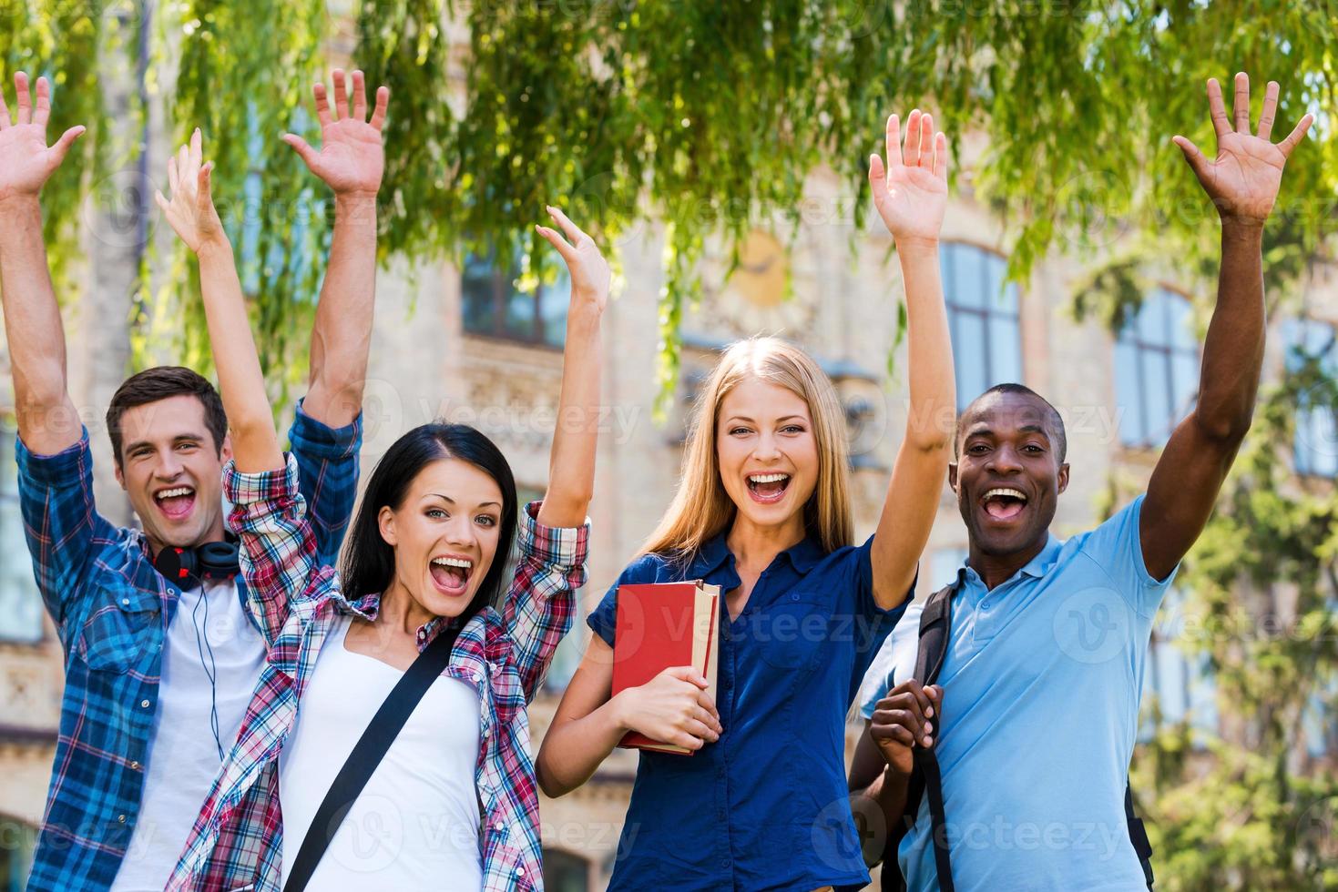 We are happy Four happy young people making selfie while standing close to each other outdoors photo