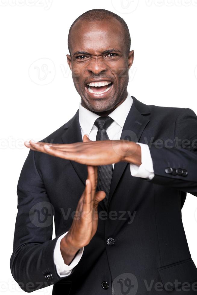 Time out Furious young African man in formalwear gesturing time out while standing isolated on white background photo