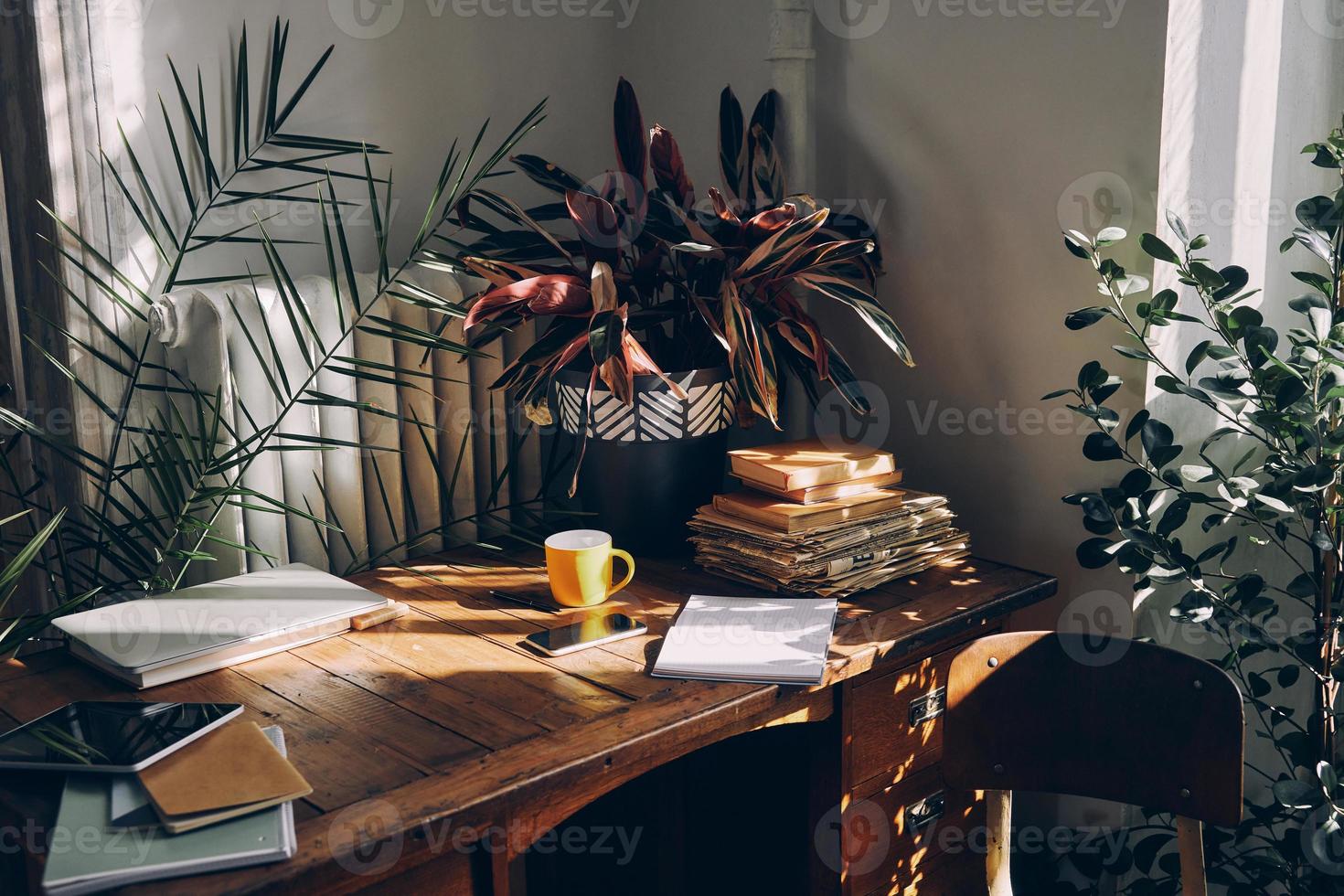 No people shot of working place with sunlight on the rustic desk photo