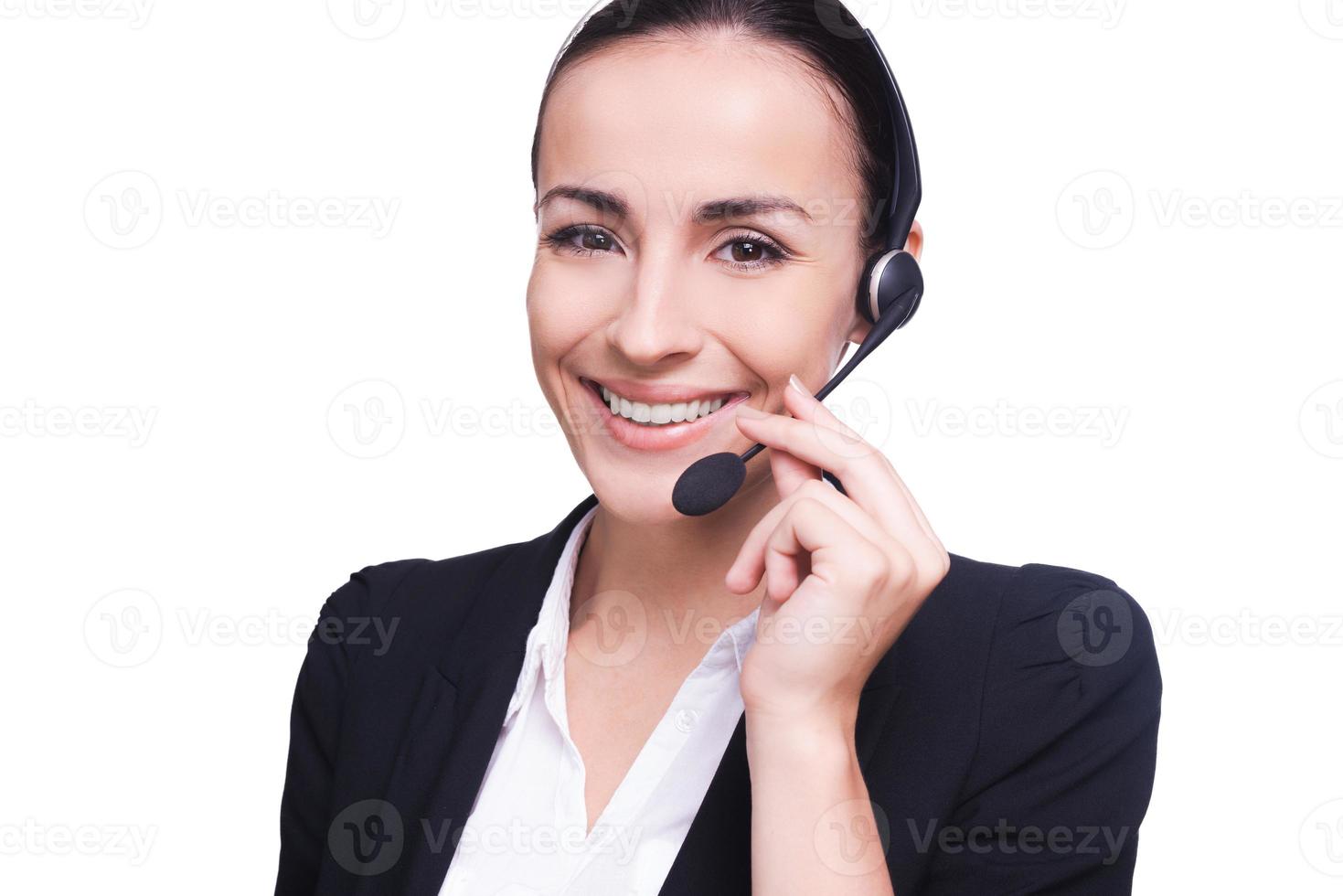 How may I help you Beautiful young woman in headset smiling and looking at camera while isolated on white photo