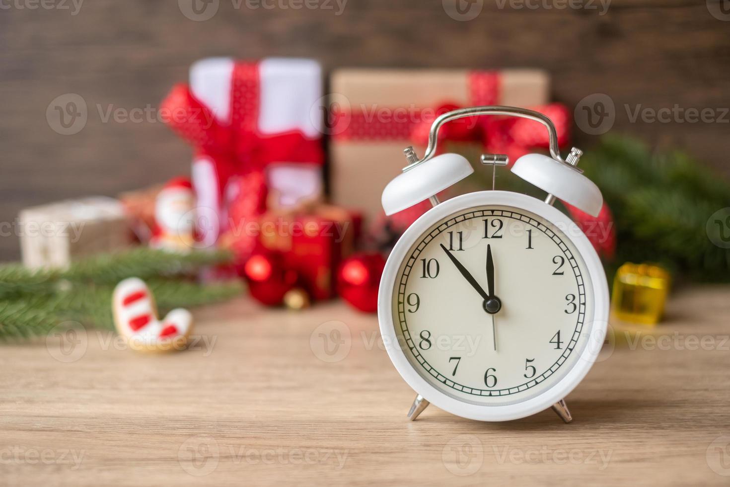 Merry Christmas with Vintage alarm clock and Xmas decoration on wooden table. party, holiday and boxing day concept photo