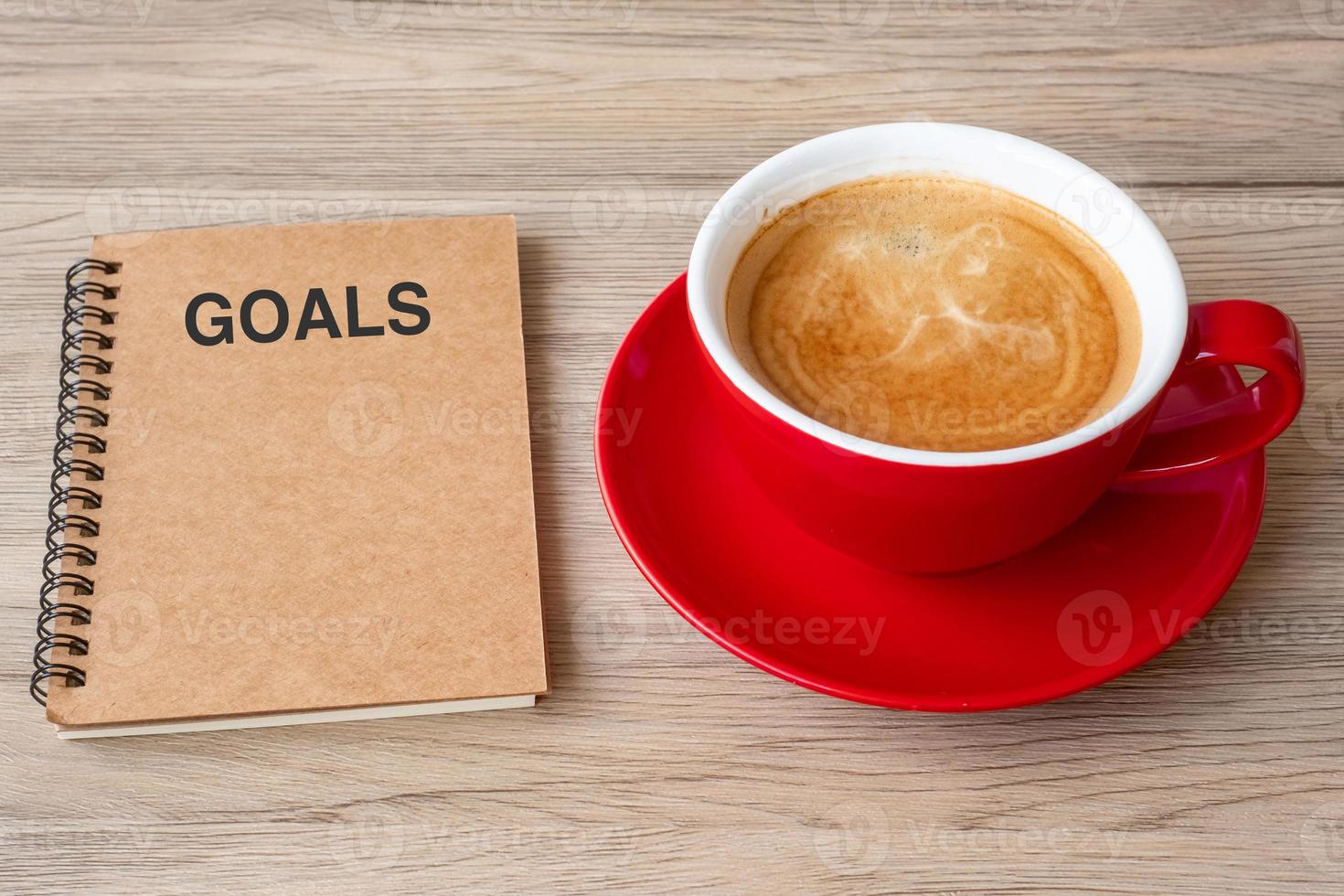 GOAL with notebook and coffee cup on wood table. Motivation, Resolution, To do list, Strategy and Plan concept photo