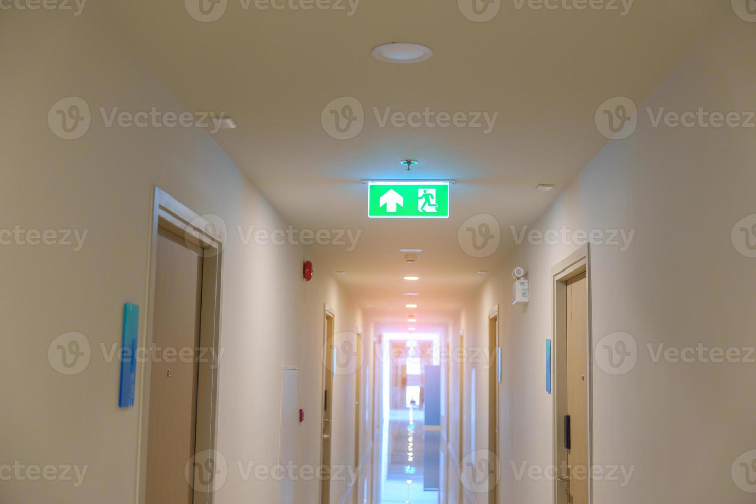 Fire Emergency exit sign on the wall background inside building. Safety concept photo