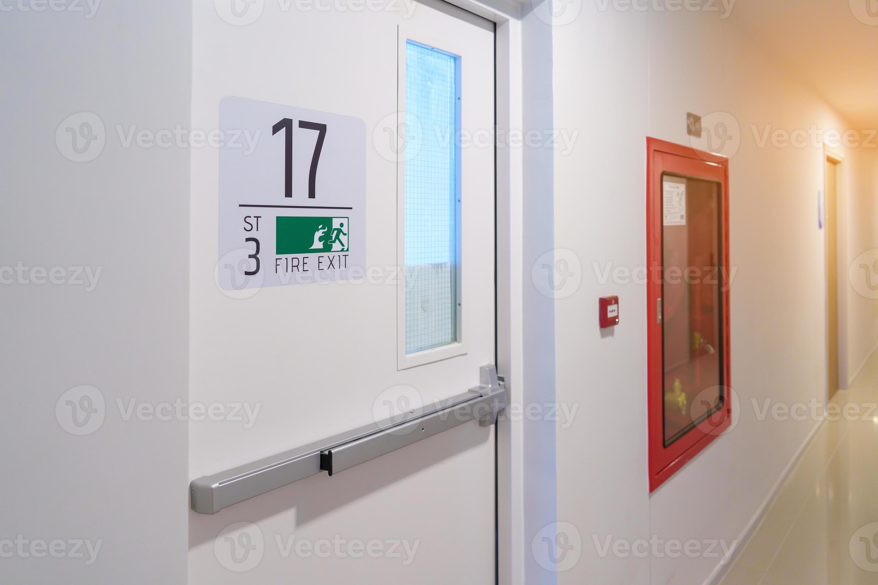 Fire extinguisher system on the wall with Fire Exit door sign for
