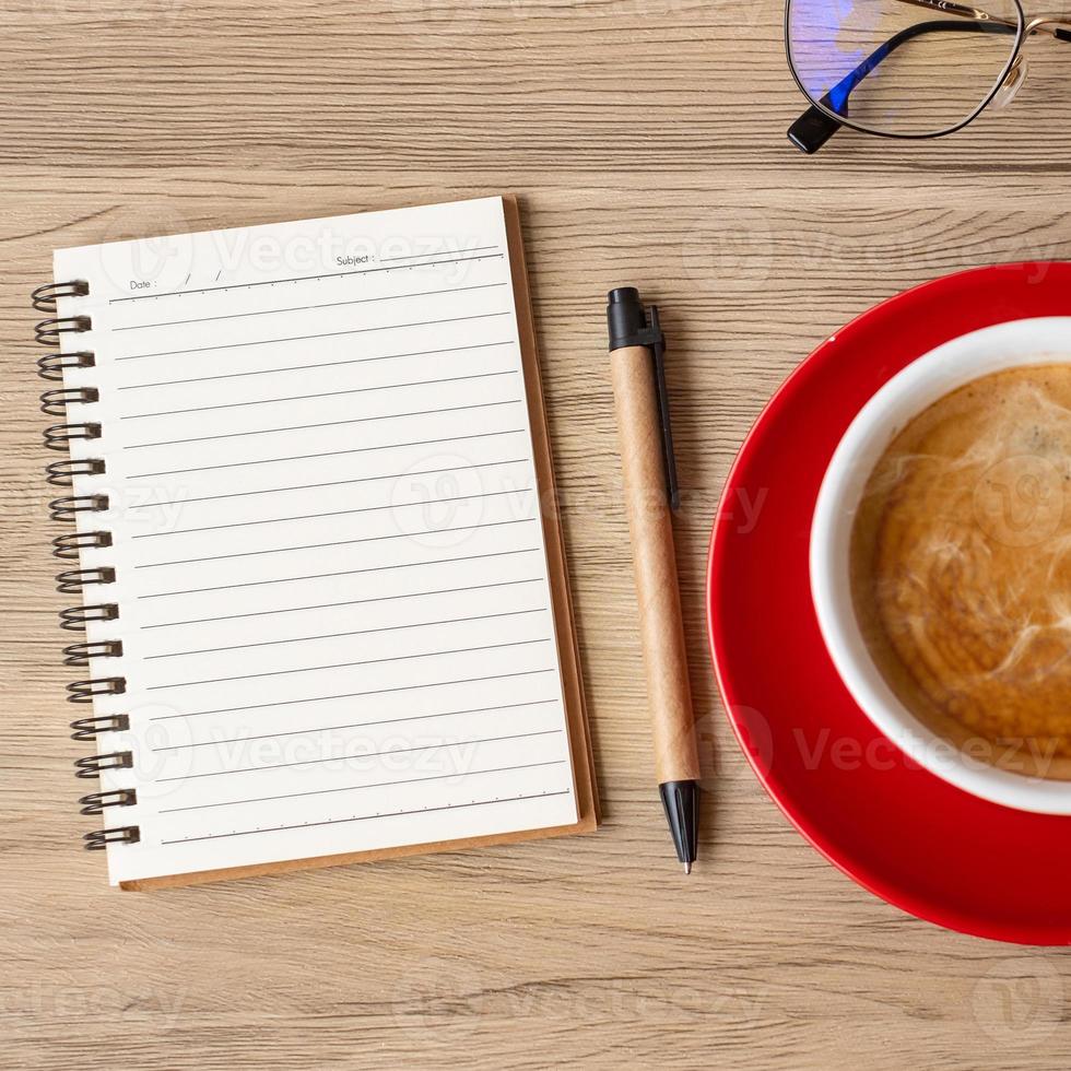 blank notebook and coffee cup on wood table. Motivation, Resolution, To do list, Strategy and Plan concept photo