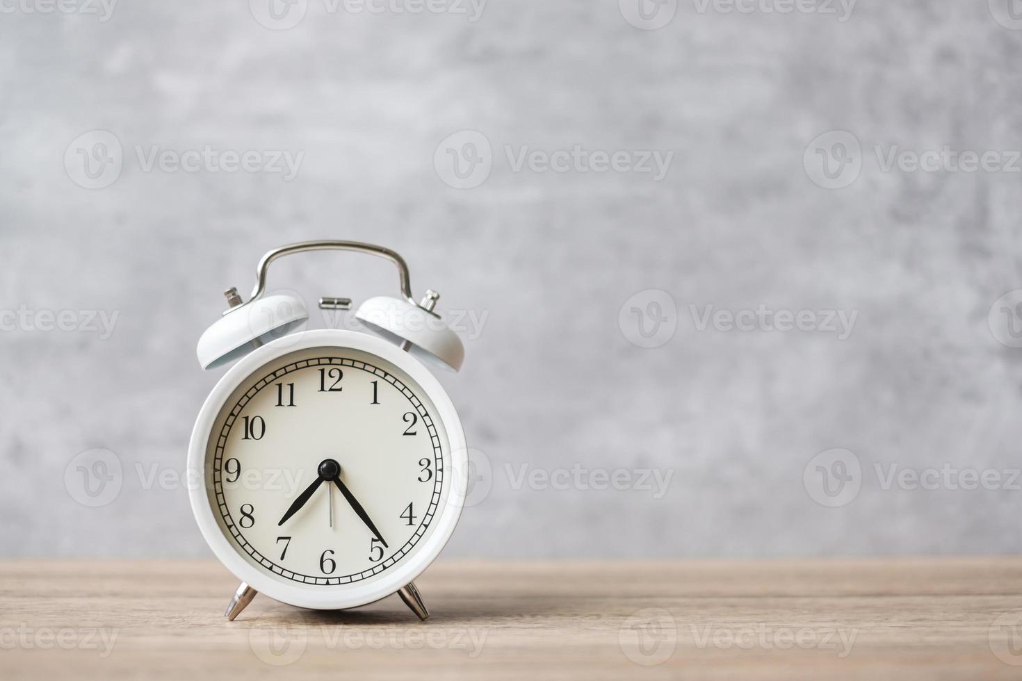 Vintage alarm clock on wooden table background and copy space for text. Activity, daily routine, morning, countdown, workout and Work life balance concept photo