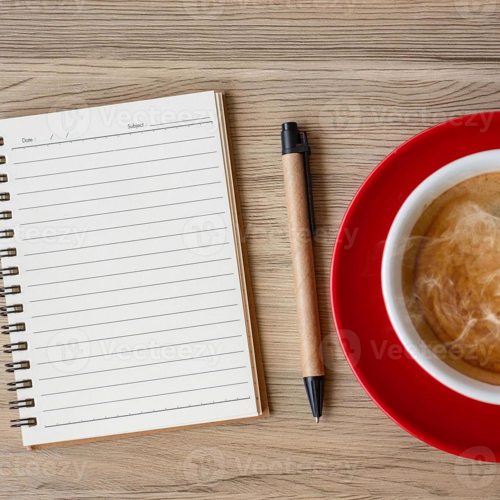blank notebook and coffee cup on wood table. Motivation, Resolution, To do list, Strategy and Plan concept photo